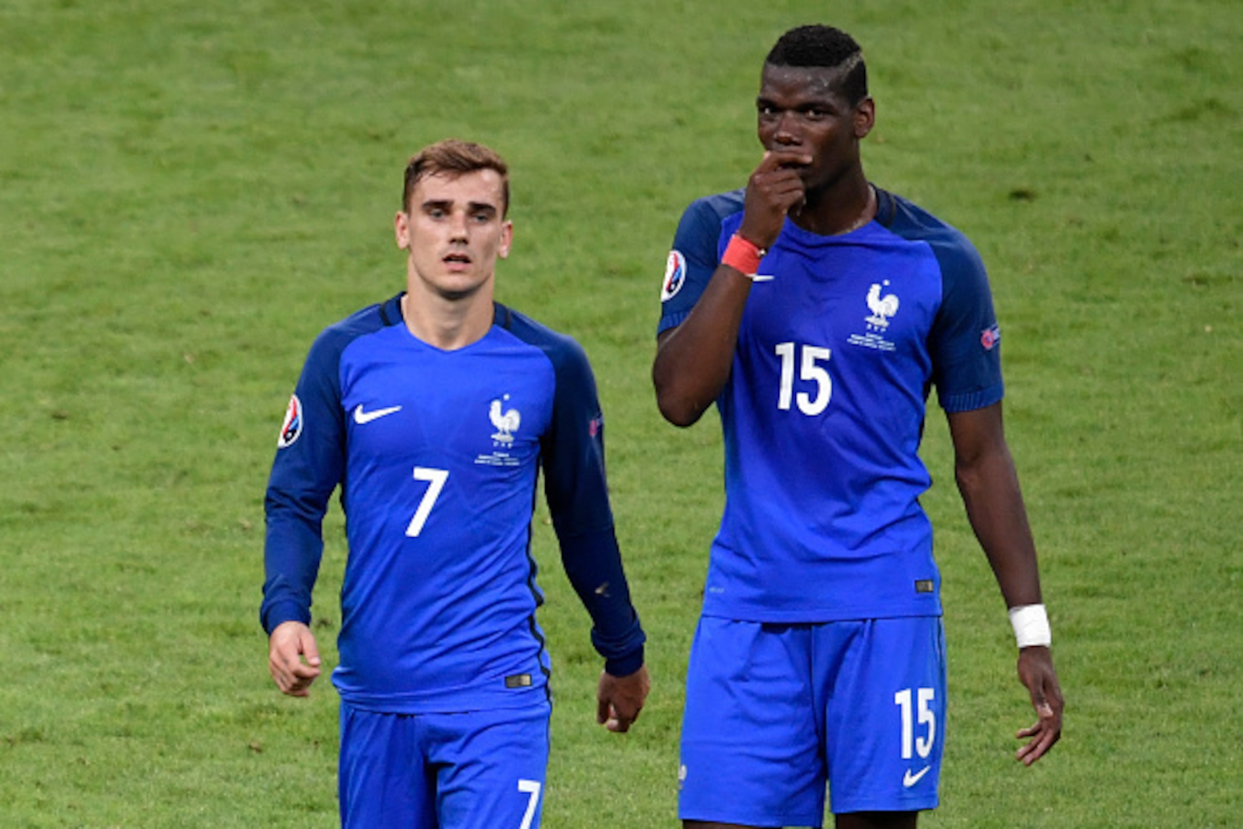 France's forward Antoine Griezmann (L) and France's midfielder Paul Pogba speak as they leave the pitch after half-time during the Euro 2016 final football match between Portugal and France at the Stade de France in Saint-Denis, north of Paris, on July 10