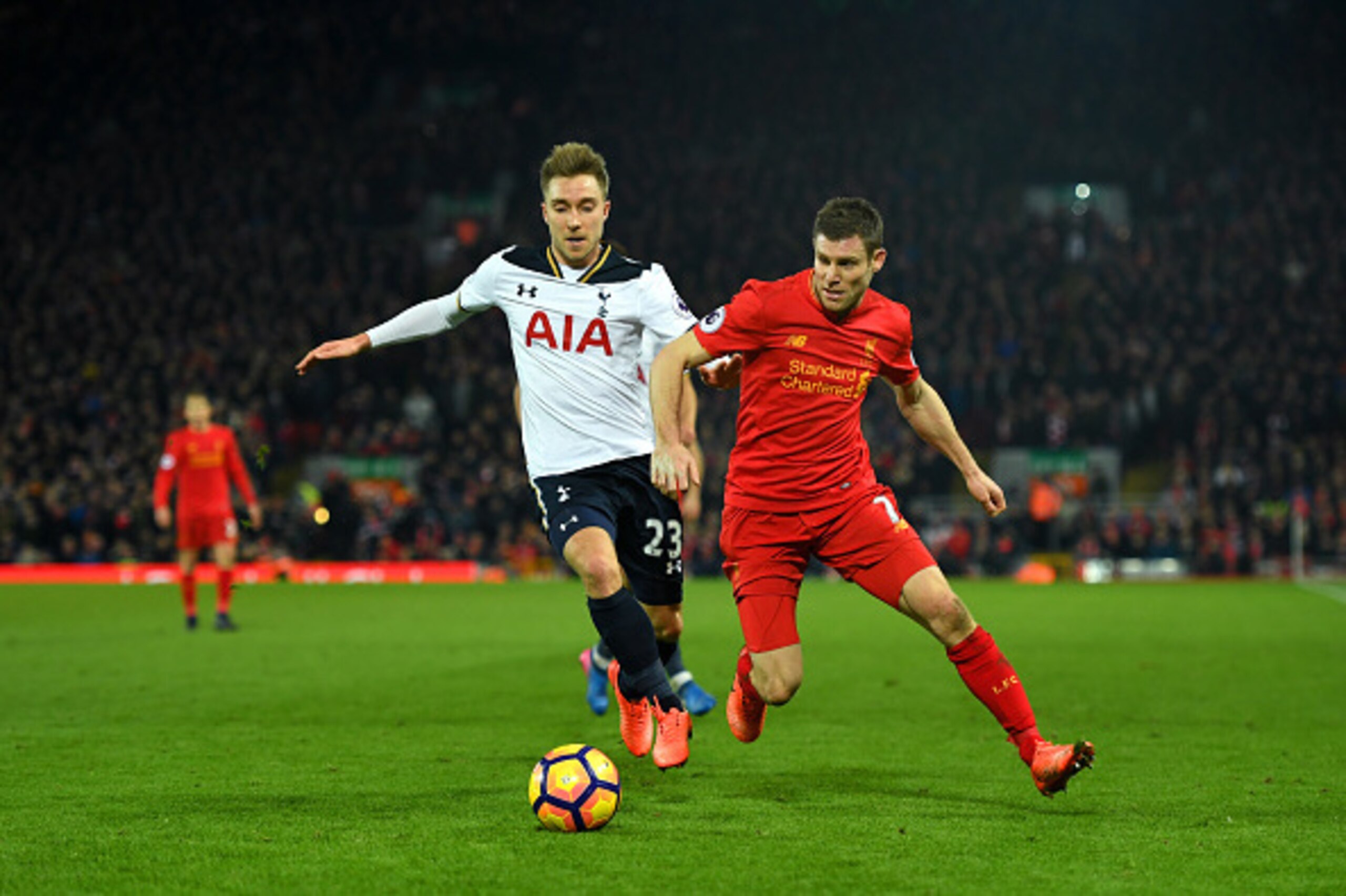 LIVERPOOL, ENGLAND - FEBRUARY 11: James Milner of Liverpool and Christian Eriksen of Tottenham Hotspur compete for the ball during the Premier League match between Liverpool and Tottenham Hotspur at Anfield on February 11, 2017 in Liverpool, England.  (Ph