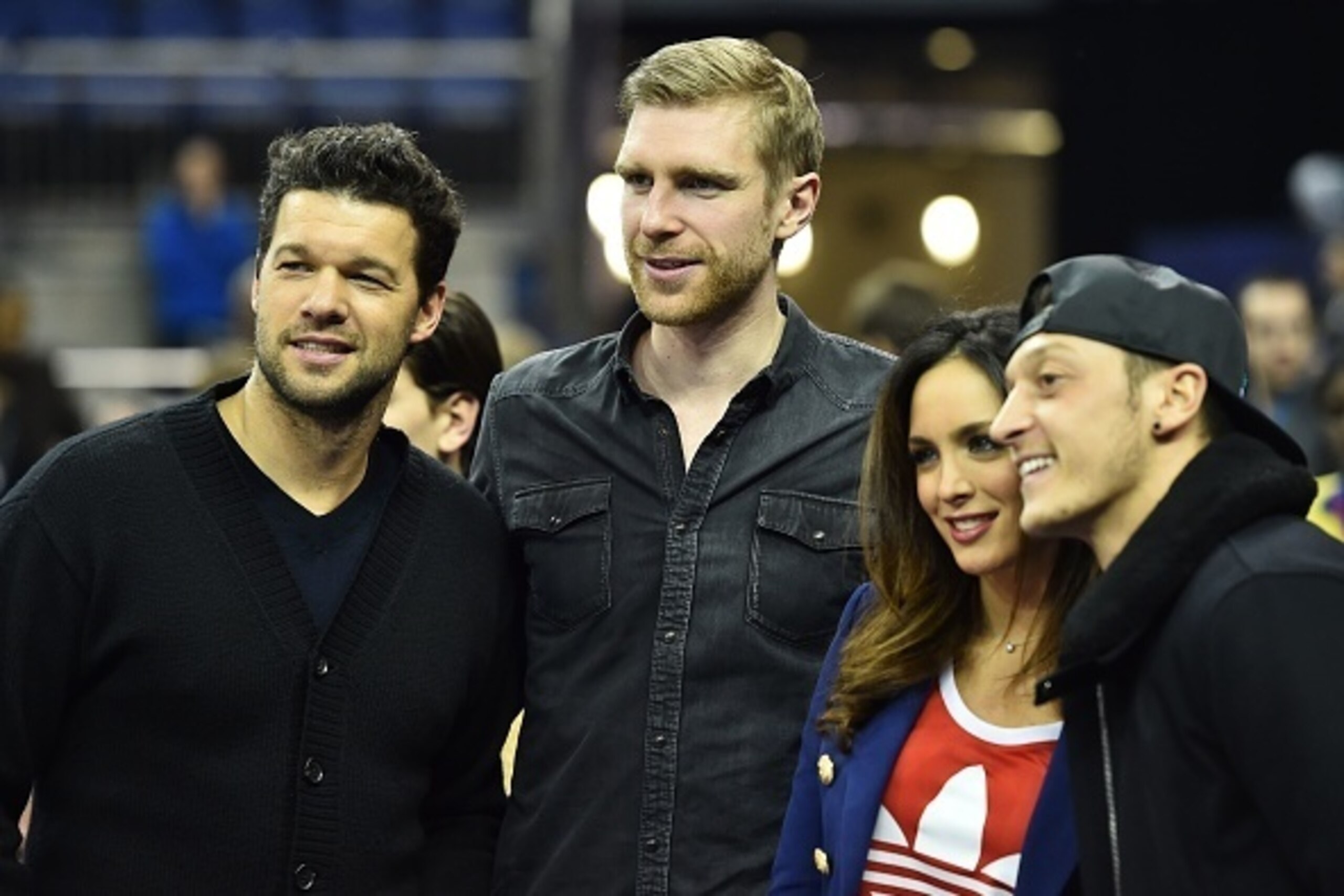 German football legend Michael Ballack (L), Arsenal's German defender Per Mertesacker (2nd L) and Arsenal's German midfielder Mesut Ozil (R) attend the NBA Global Game London 2017 basketball game between Indiana Pacers and Denver Nuggets at the O2 Arena i