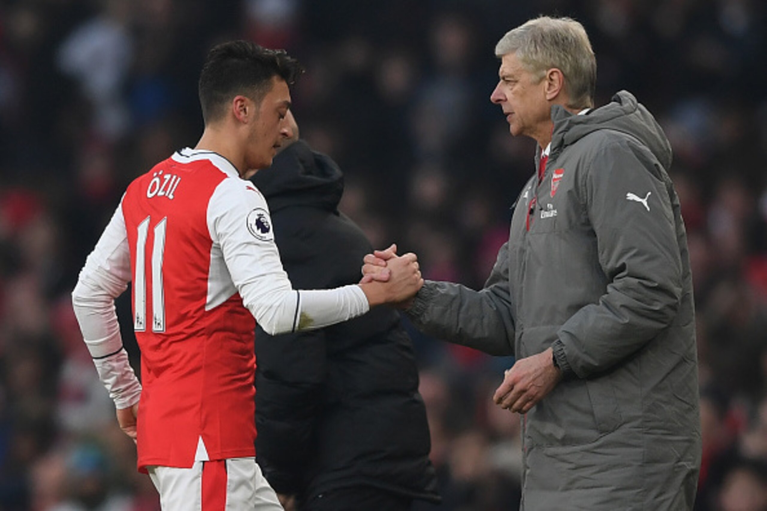 LONDON, ENGLAND - JANUARY 22: Mesut Ozil of Arsenal shakes hands with Arsene Wenger, Manager of Arsenal after substituted during the Premier League match between Arsenal and Burnley at the Emirates Stadium on January 22, 2017 in London, England.  (Photo b