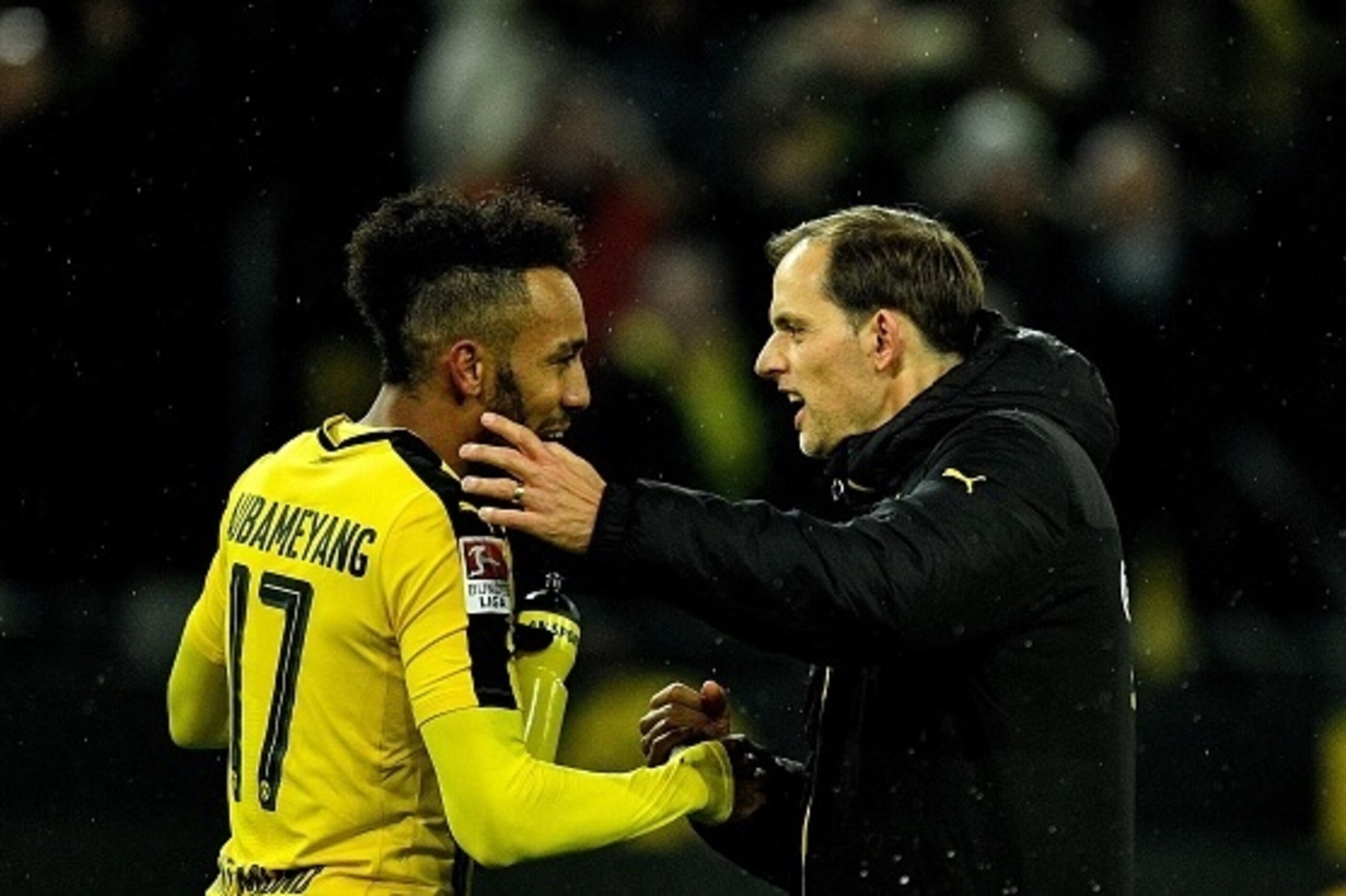 Dortmund's head coach Thomas Tuchel celebrates with Dortmund's Gabonese forward Pierre-Emerick Aubameyang after the German First division Bundesliga football match between Borussia Dortmund and RB Leipzig, in Dortmund, western Germany, on February 4, 2017