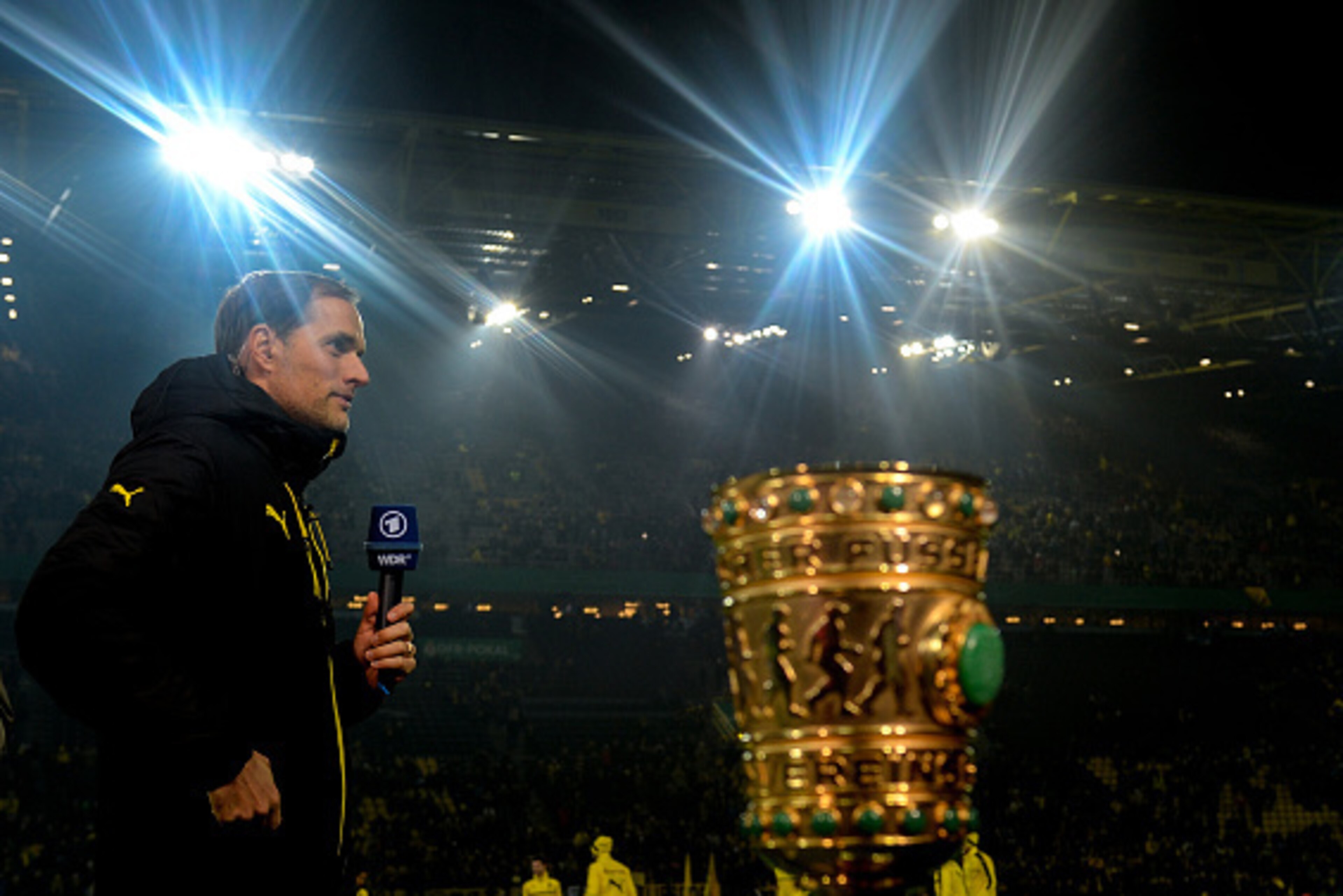 Dortmund's head coach Thomas Tuchel gives an interview next to the trophy prior to the German Cup DFB Pokal round of 16 football match BVB Borussia Dortmund v Hertha Berlin in Dortmund, western Germany on February 8, 2017. / AFP / SASCHA SCHUERMANN / REST