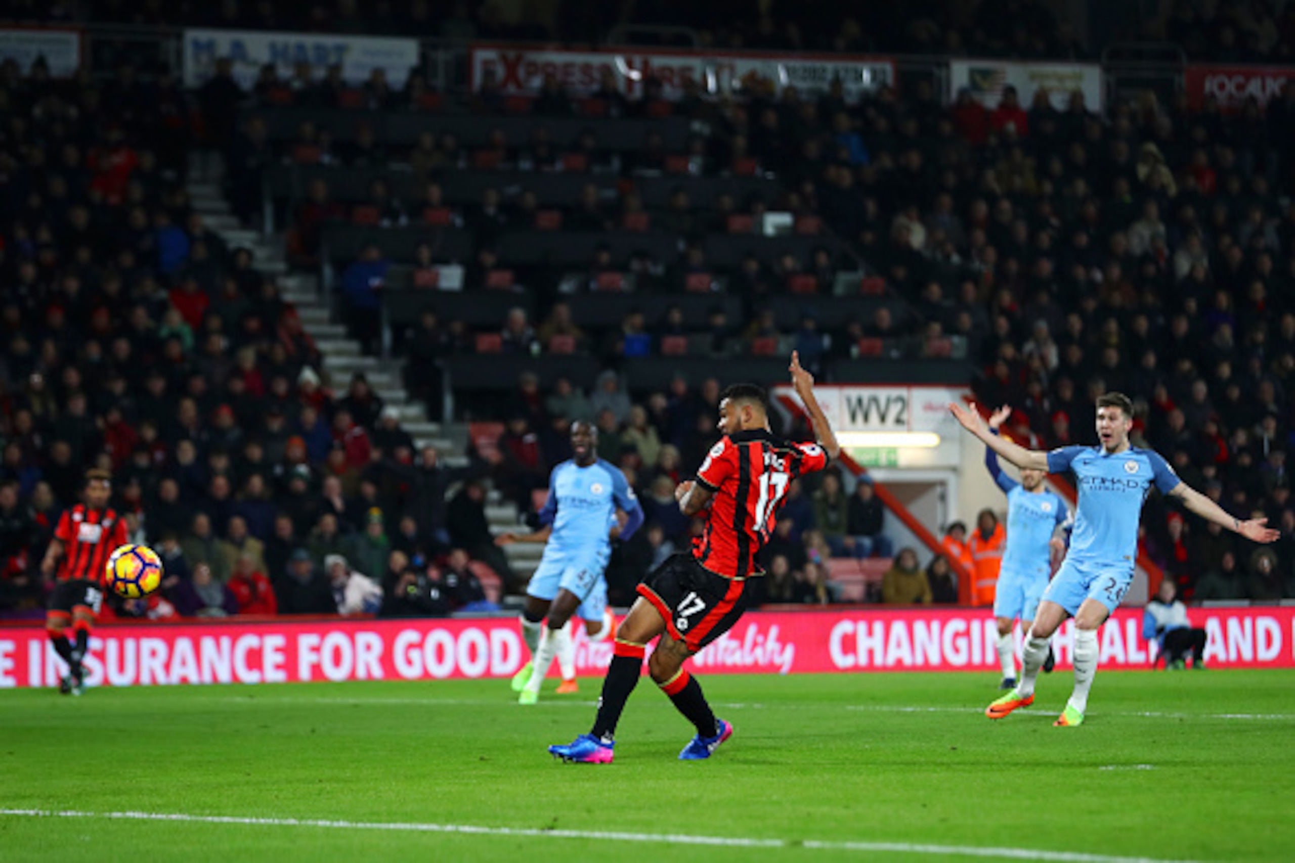 BOURNEMOUTH, ENGLAND - FEBRUARY 13:  Joshua King of Bournemouth scores a disallowed goal after pulling on the shirt of John Stones of Manchester City on his run through during the Premier League match between AFC Bournemouth and Manchester City at Vitalit