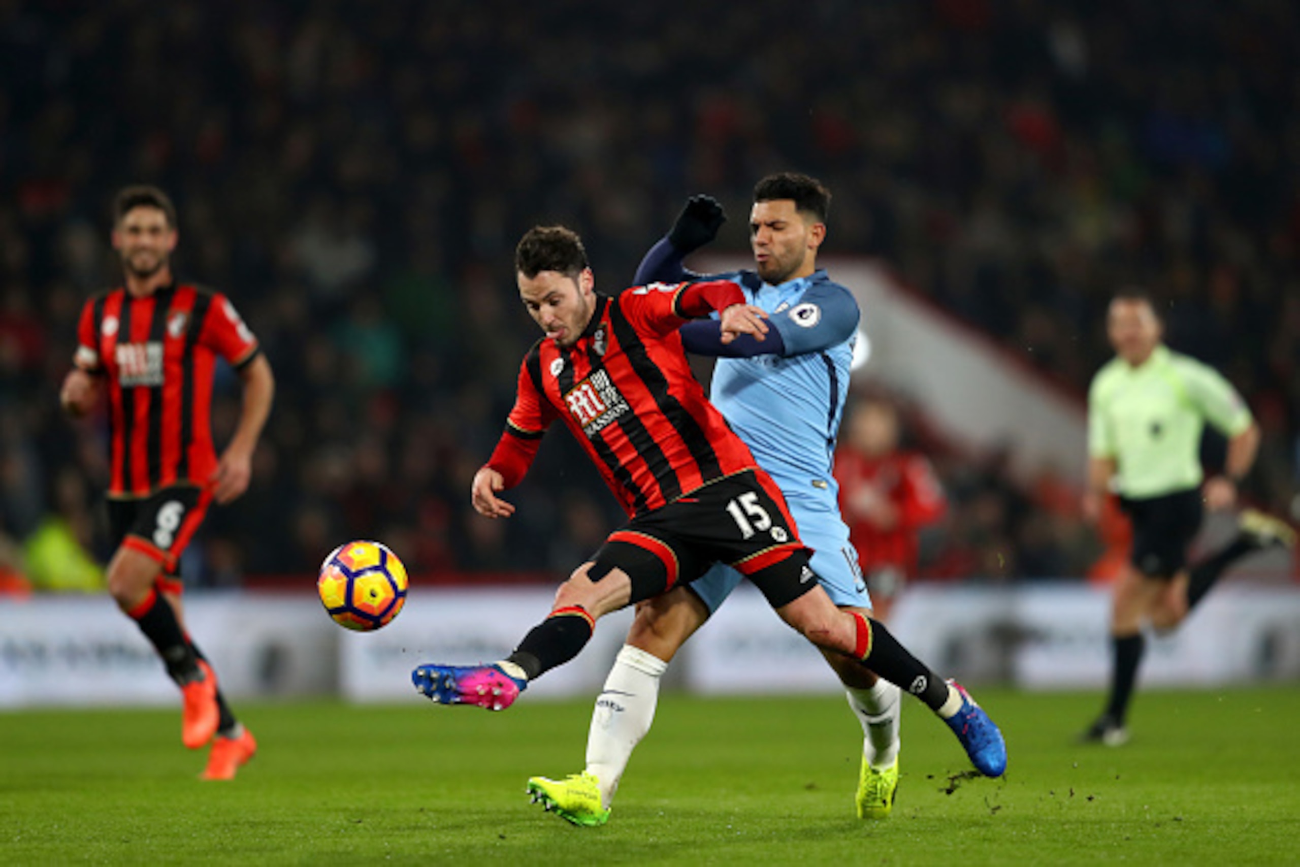 BOURNEMOUTH, ENGLAND - FEBRUARY 13:  Adam Smith of Bournemouth clears the ball in front of Sergio Aguero of Manchester City during the Premier League match between AFC Bournemouth and Manchester City at Vitality Stadium on February 13, 2017 in Bournemouth