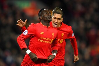 LIVERPOOL, ENGLAND - FEBRUARY 11:  Sadio Mane (L) of Liverpool celebrates scoring the oprning goal with his team mate Roberto Firmino (R) during the Premier League match between Liverpool and Tottenham Hotspur at Anfield on February 11, 2017 in Liverpool,