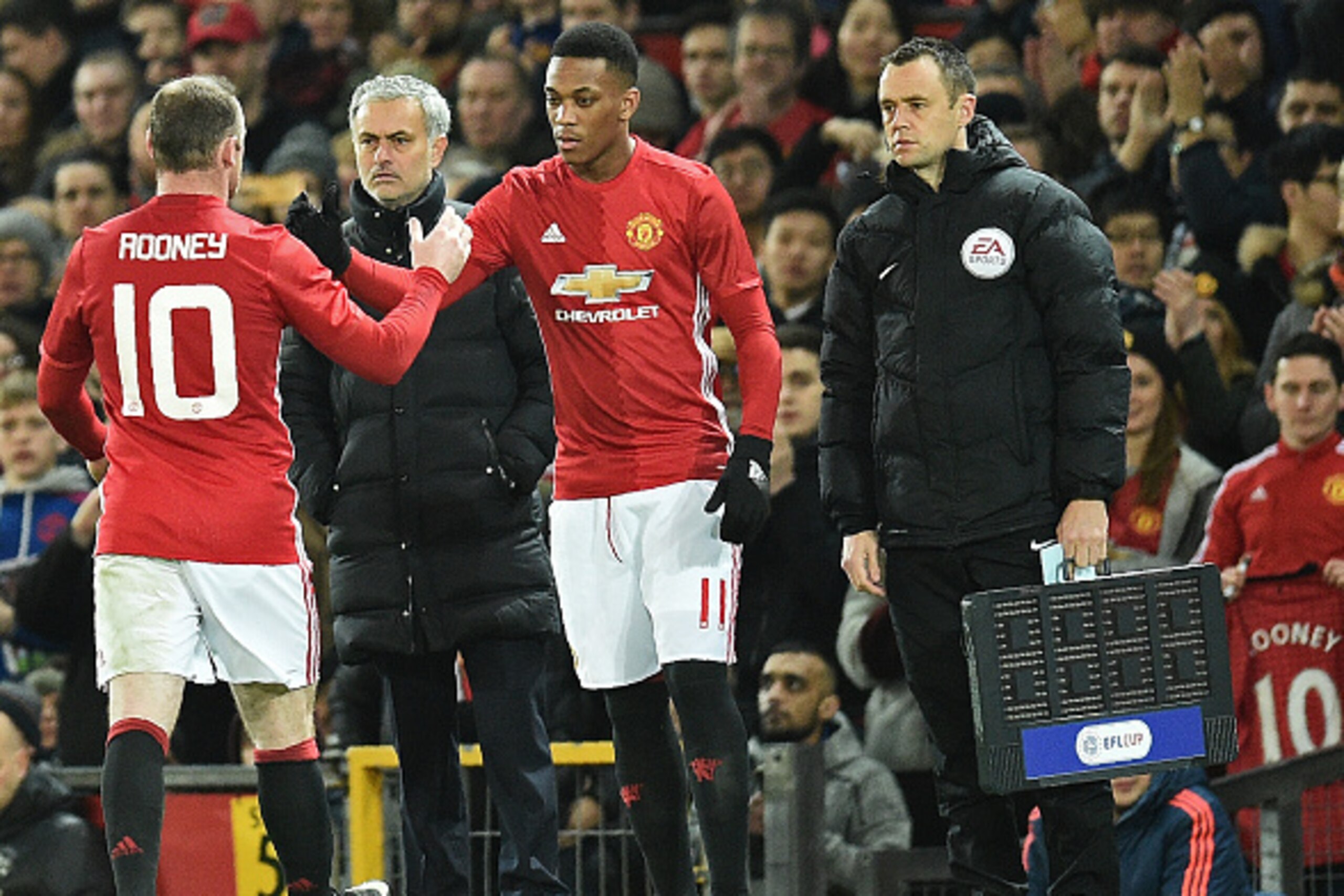Manchester United's Portuguese manager Jose Mourinho (2L) watches as Manchester United's French striker Anthony Martial (C) is substitued onto the pitch for Manchester United's English striker Wayne Rooney during the EFL (English Football League) Cup semi