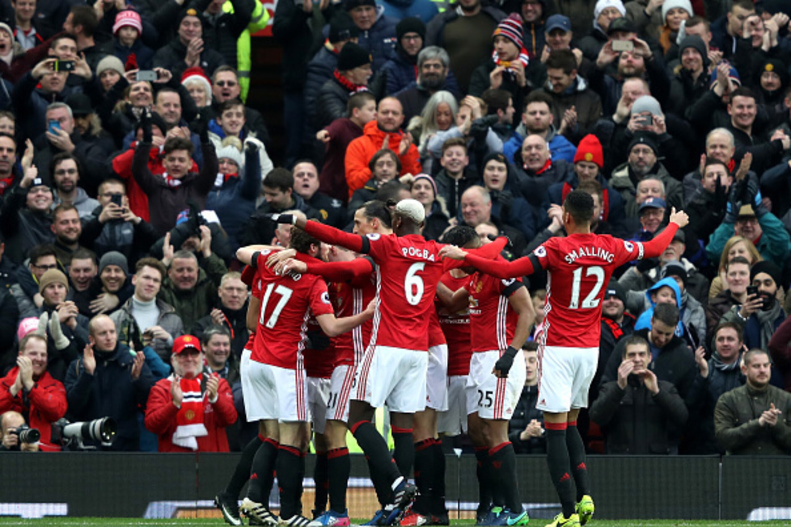 MANCHESTER, ENGLAND - FEBRUARY 11: Manchester United players celebrate their first goal by Juan Mata (obscured) during the Premier League match between Manchester United and Watford at Old Trafford on February 11, 2017 in Manchester, England.  (Photo by M