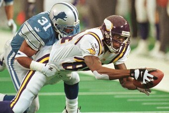 PONTIAC, :  Detroit Lions defender J.B. Brown (L) brings down Minnesota Vikings receiver Randy Moss during their 17 October 1999 game at the Silverdome in Pontiac, Michigan. The Lions beat the Vikings 25-23 dropping their record to 2-4. . AFP PHOTO/Jeff K