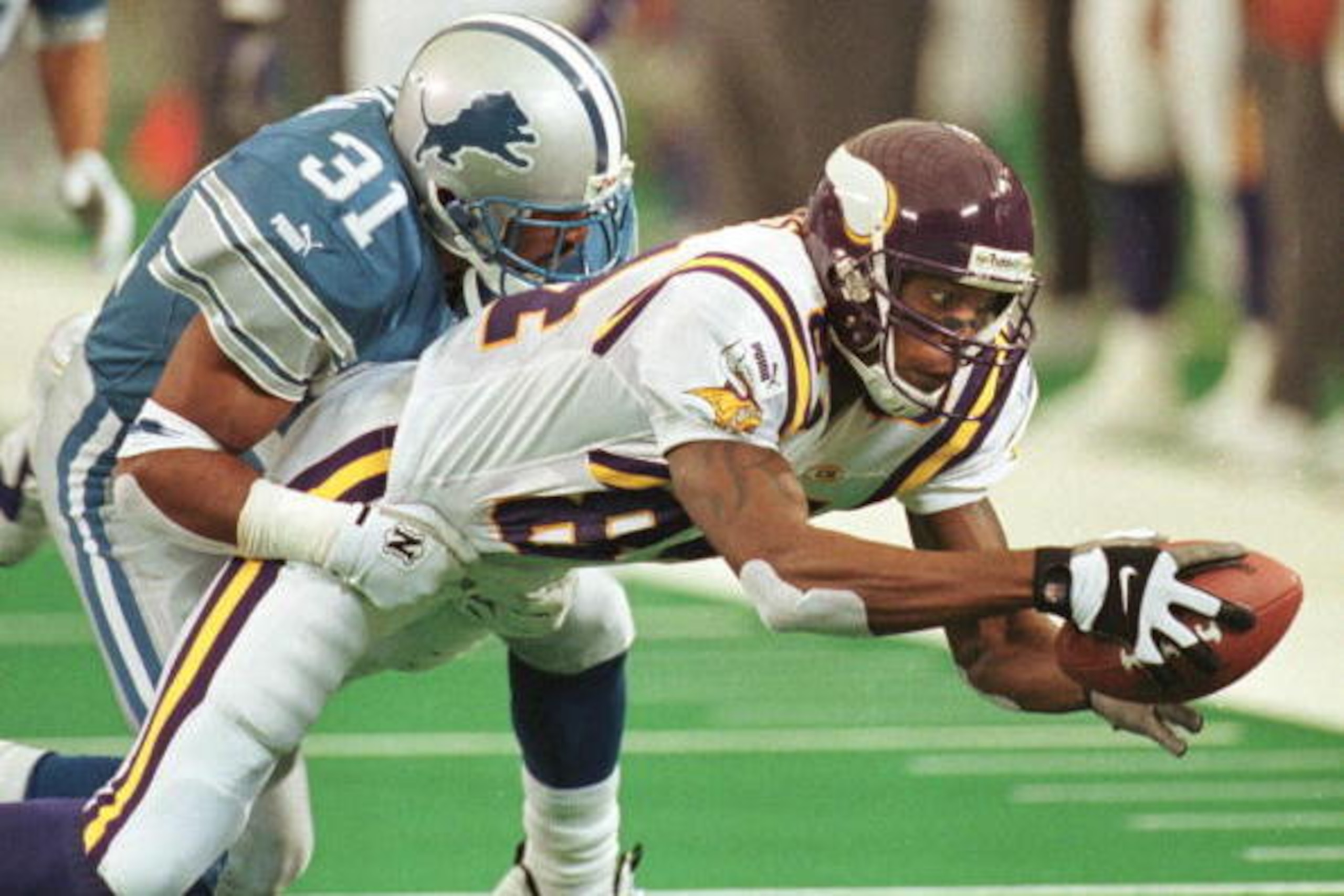 PONTIAC, :  Detroit Lions defender J.B. Brown (L) brings down Minnesota Vikings receiver Randy Moss during their 17 October 1999 game at the Silverdome in Pontiac, Michigan. The Lions beat the Vikings 25-23 dropping their record to 2-4. . AFP PHOTO/Jeff K