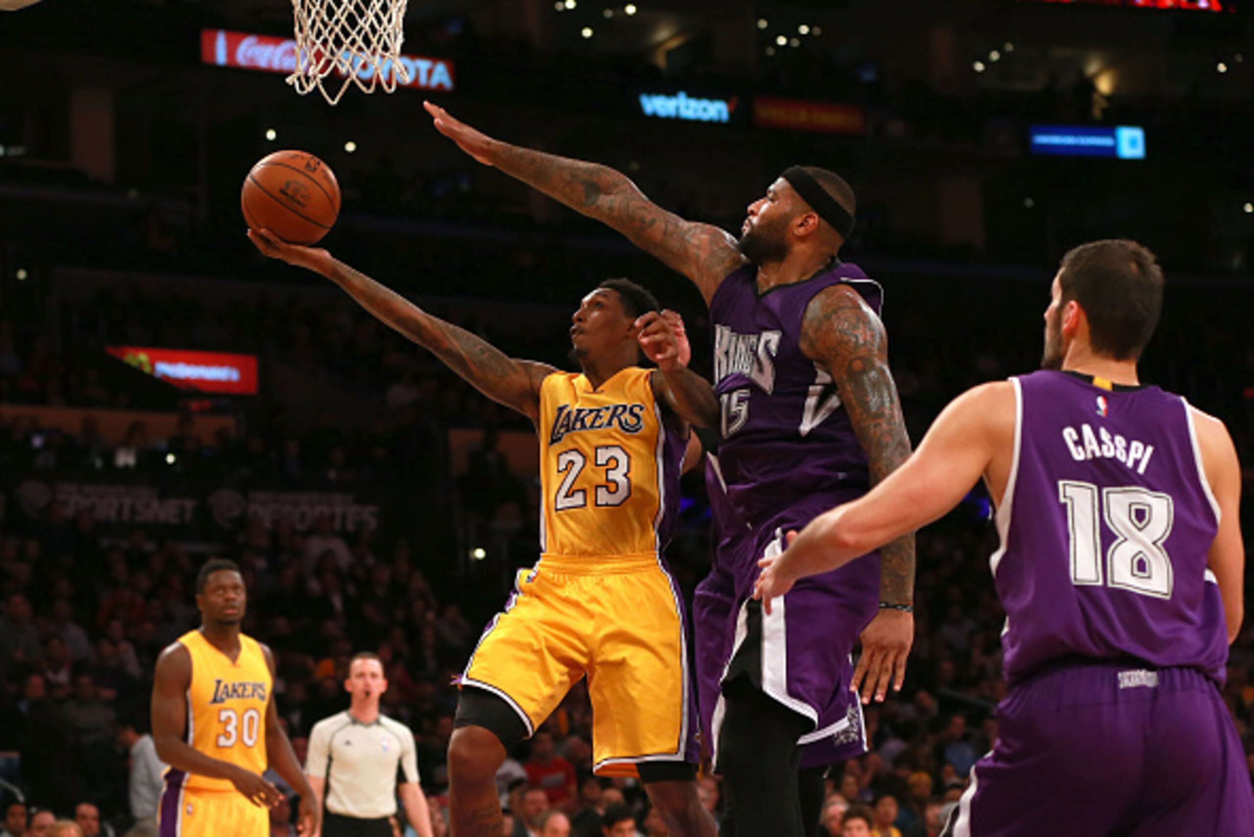 LOS ANGELES, CA - JANUARY 20:  Lou Williams #23 of the Los Angeles Lakers lays up a shot against DeMarcus Cousins #15 of the Sacramento Kings during the NBA game at Staples Center on January 20, 2016 in Los Angeles, California. The Kings defeated the Lake