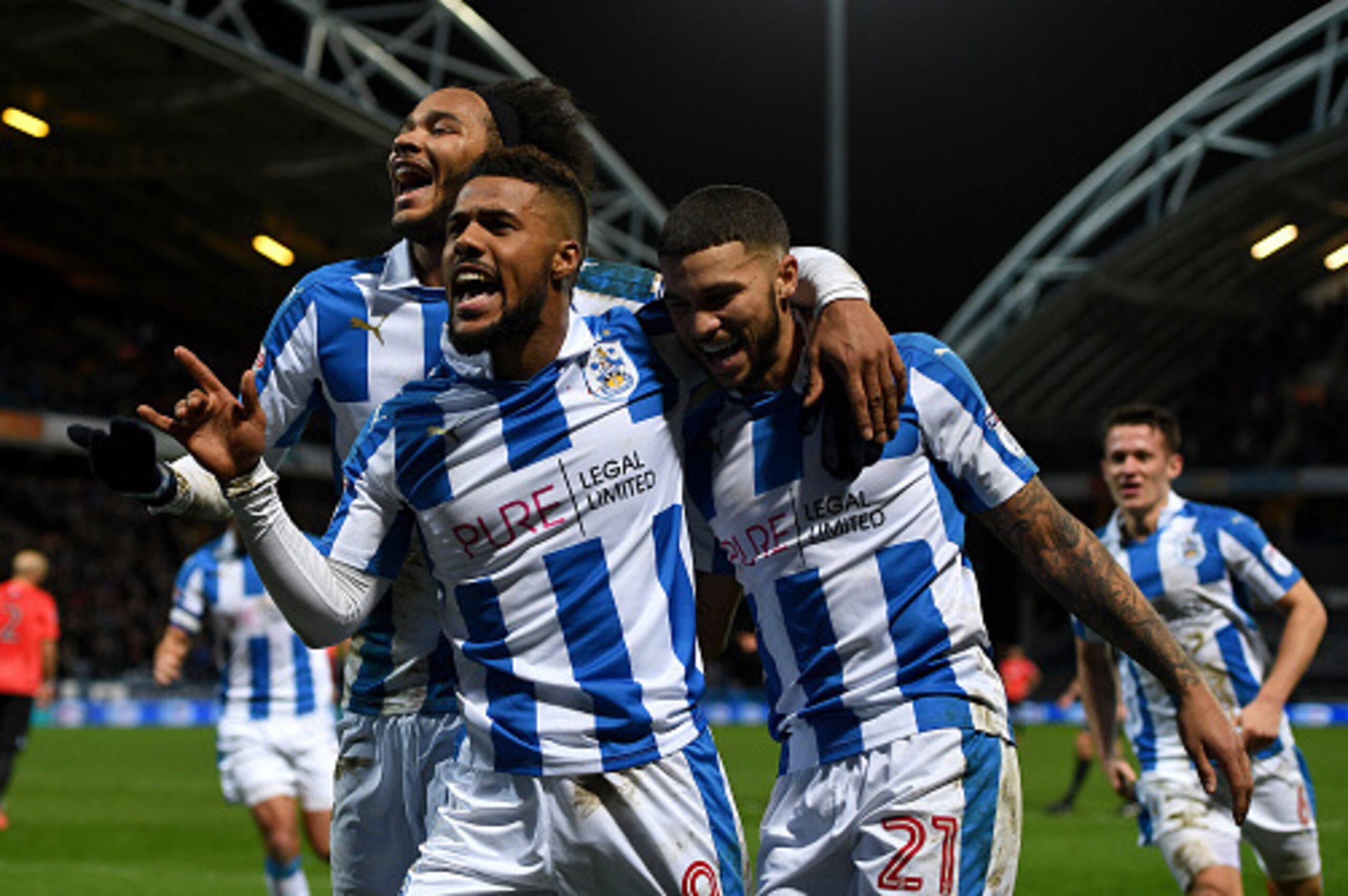 HUDDERSFIELD, ENGLAND - FEBRUARY 02:  Elias Kachunga of Huddersfield celebrates with Isaiah Brown and Nahki Wells after scoring his team's 3rd goal during the Sky Bet Championship match between Huddersfield Town and Brighton & Hove Albion at Galpharm Stad