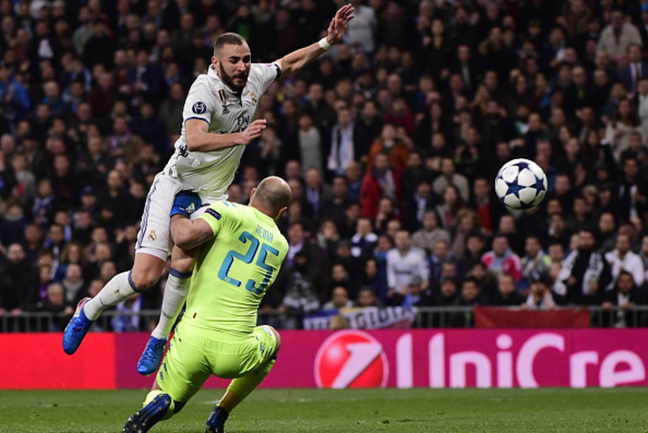 Real Madrid's French forward Karim Benzema (L) vies with Napoli's goalkeeper from Spain Pepe Reina during the UEFA Champions League round of 16 first leg football match Real Madrid CF vs SSC Napoli at the Santiago Bernabeu stadium in Madrid on February 15 Real Madrid's French forward Karim Benzema (L) vies with Napoli's goalkeeper from Spain Pepe Reina during the UEFA Champions League round of 16 first leg football match Real Madrid CF vs SSC Napoli at the Santiago Bernabeu stadium in Madrid on February 15