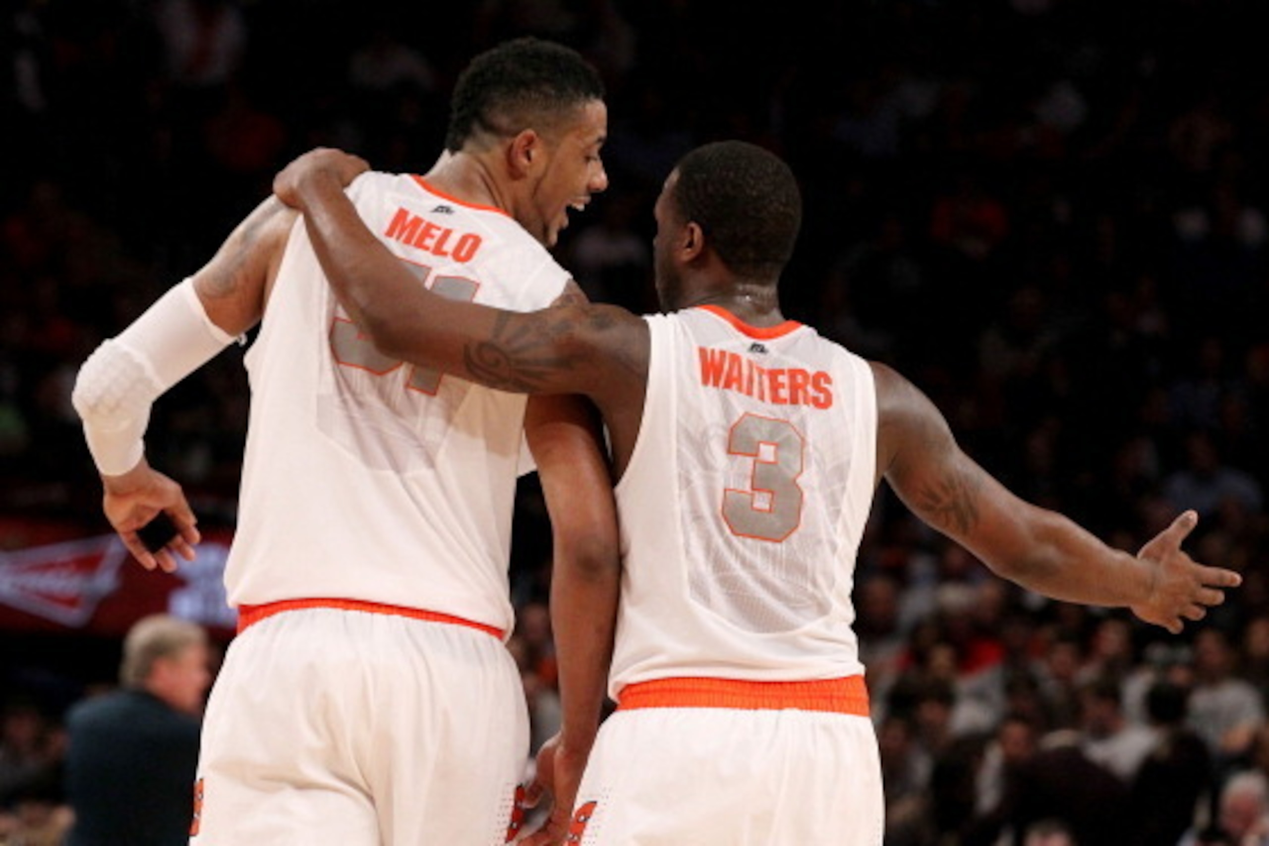 NEW YORK, NY - MARCH 08:  Fab Melo #51 and Dion Waiters #3 of the Syracuse Orange talk against the Connecticut Huskies during the quarterfinals of the Big East Men's Basketball Tournament at Madison Square Garden on March 8, 2012 in New York City.  (Photo