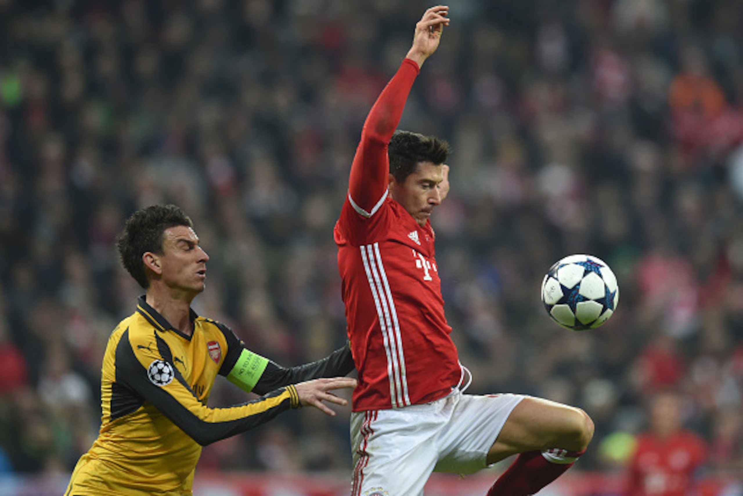 Arsenal's Swiss midfielder Granit Xhaka (L) and Bayern Munich's Polish striker Robert Lewandowski (R) vie for the ball during the UEFA Champions League round of sixteen football match between FC Bayern Munich and Arsenal in Munich, southern Germany, on Fe Arsenal's Swiss midfielder Granit Xhaka (L) and Bayern Munich's Polish striker Robert Lewandowski (R) vie for the ball during the UEFA Champions League round of sixteen football match between FC Bayern Munich and Arsenal in Munich, southern Germany, on Fe