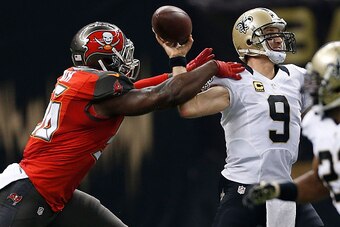 NEW ORLEANS, LA - SEPTEMBER 20:  Drew Brees #9 of the New Orleans Saints is hit by Jacquies Smith #56 of the Tampa Bay Buccaneers during the first quarter of a game at the Mercedes-Benz Superdome on September 20, 2015 in New Orleans, Louisiana.  (Photo by