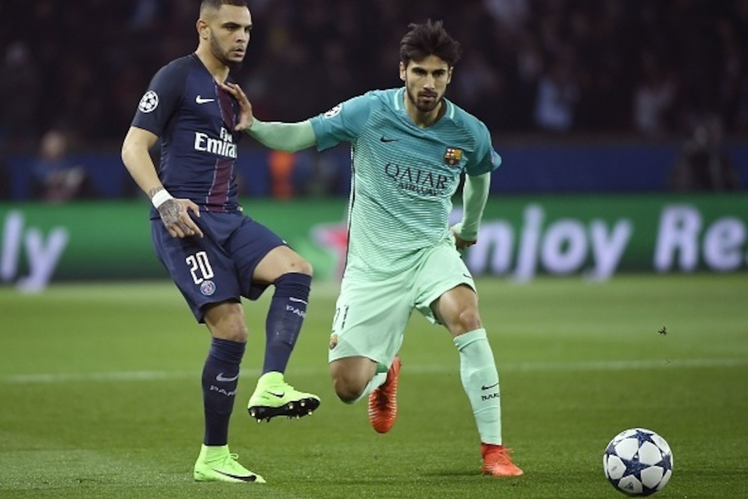 Paris Saint-Germain's French defender Layvin Kurzawa (L) vies with Barcelona's Portuguese midfielder Andre Gomes during the UEFA Champions League round of 16 first leg football match between Paris Saint-Germain and FC Barcelona on February 14, 2017 at the