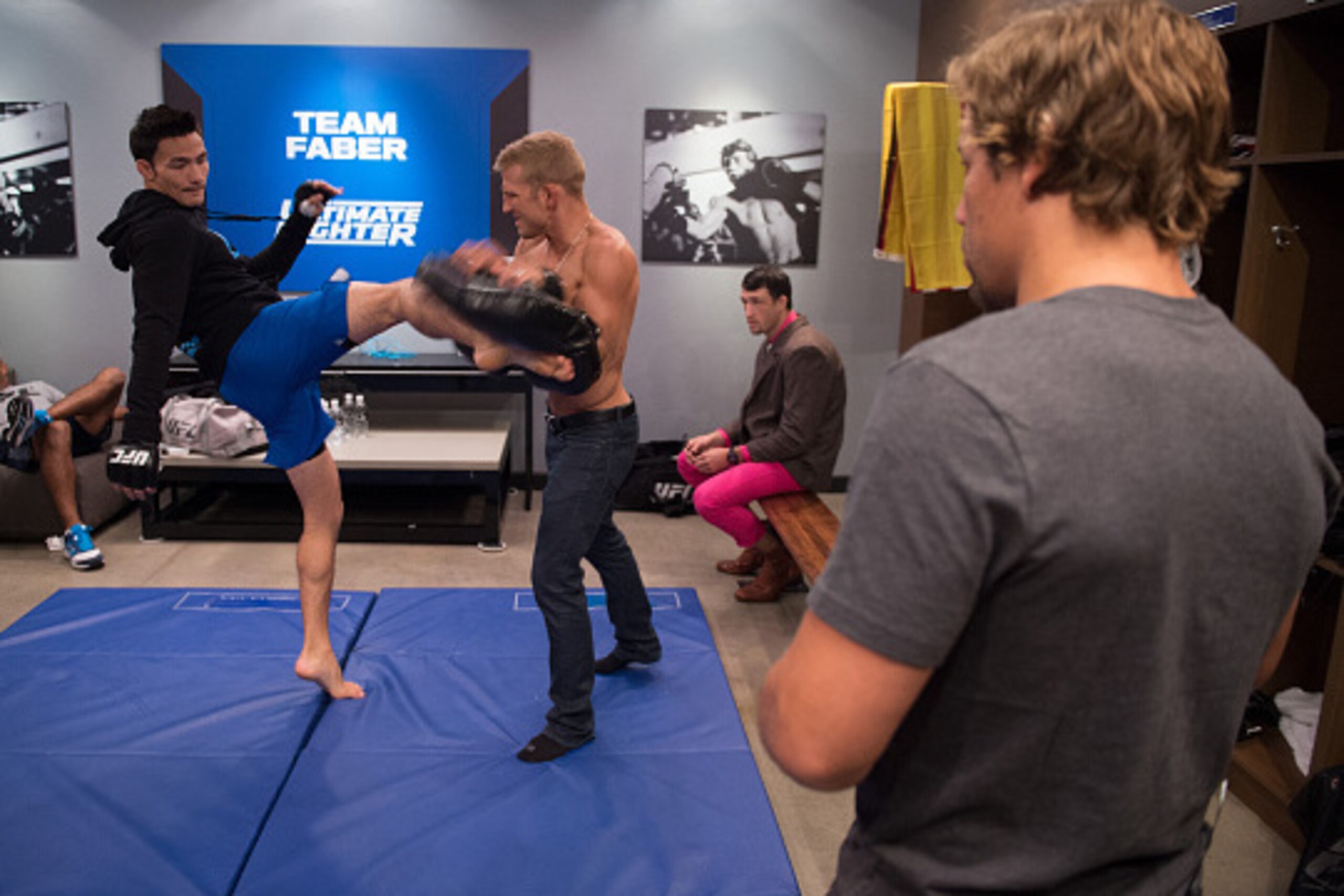 LAS VEGAS, NV - AUGUST 07:  Head coach Uriah Faber watches as Thanh Le warms up with assistant coach TJ Dillashaw before facing Martin Svensson during the filming of The Ultimate Fighter: Team McGregor vs Team Faber at the UFC TUF Gym on August 7, 2015 in