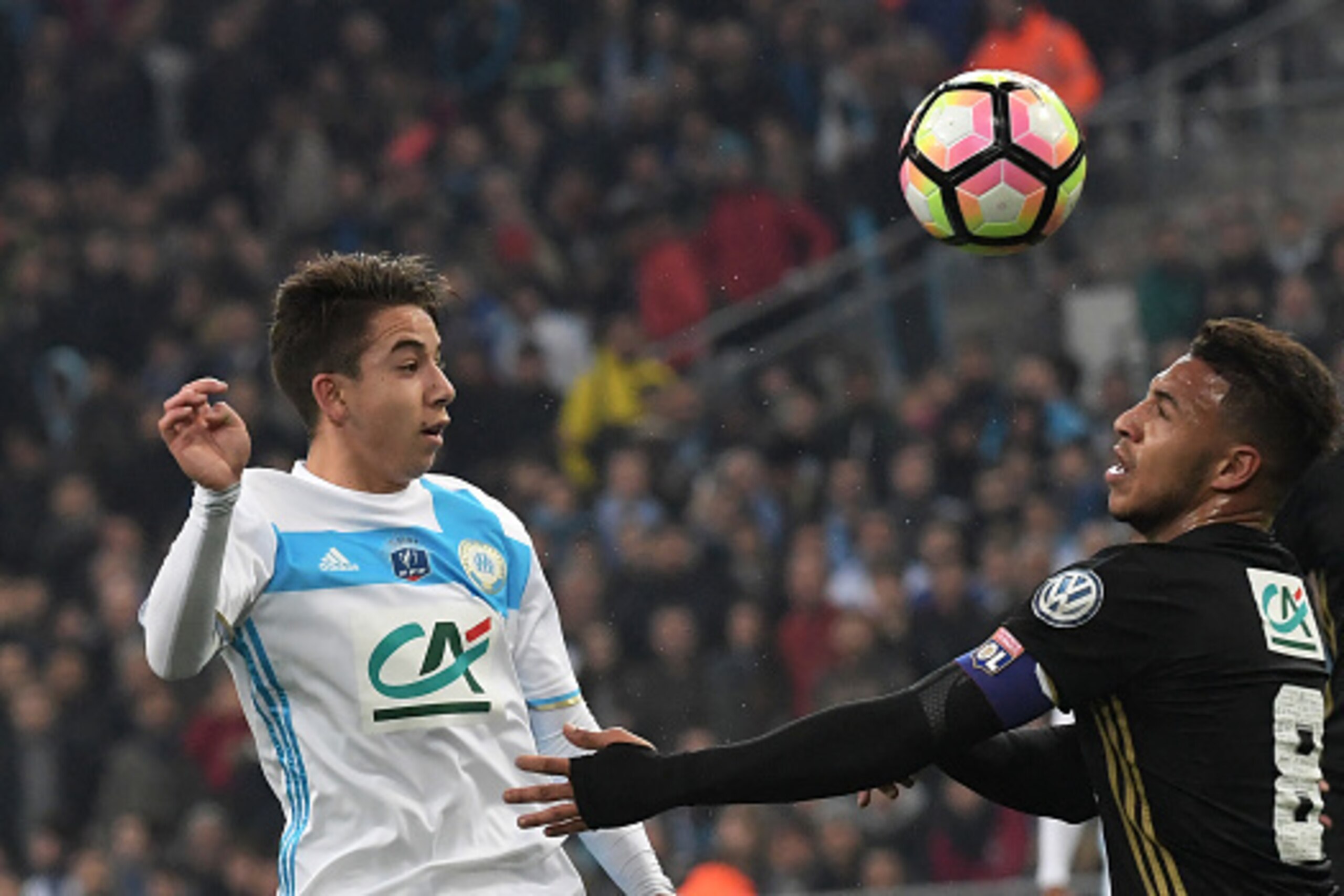 Olympique de Marseille's French midfielder Maxime Lopez (L) vies with Lyon's French midfielder Coretin Tolisso (R) during the French Cup football match Marseille vs Lyon, on January 31, 2017 at the Velodrome stadium in Marseille, southern France. / AFP / 