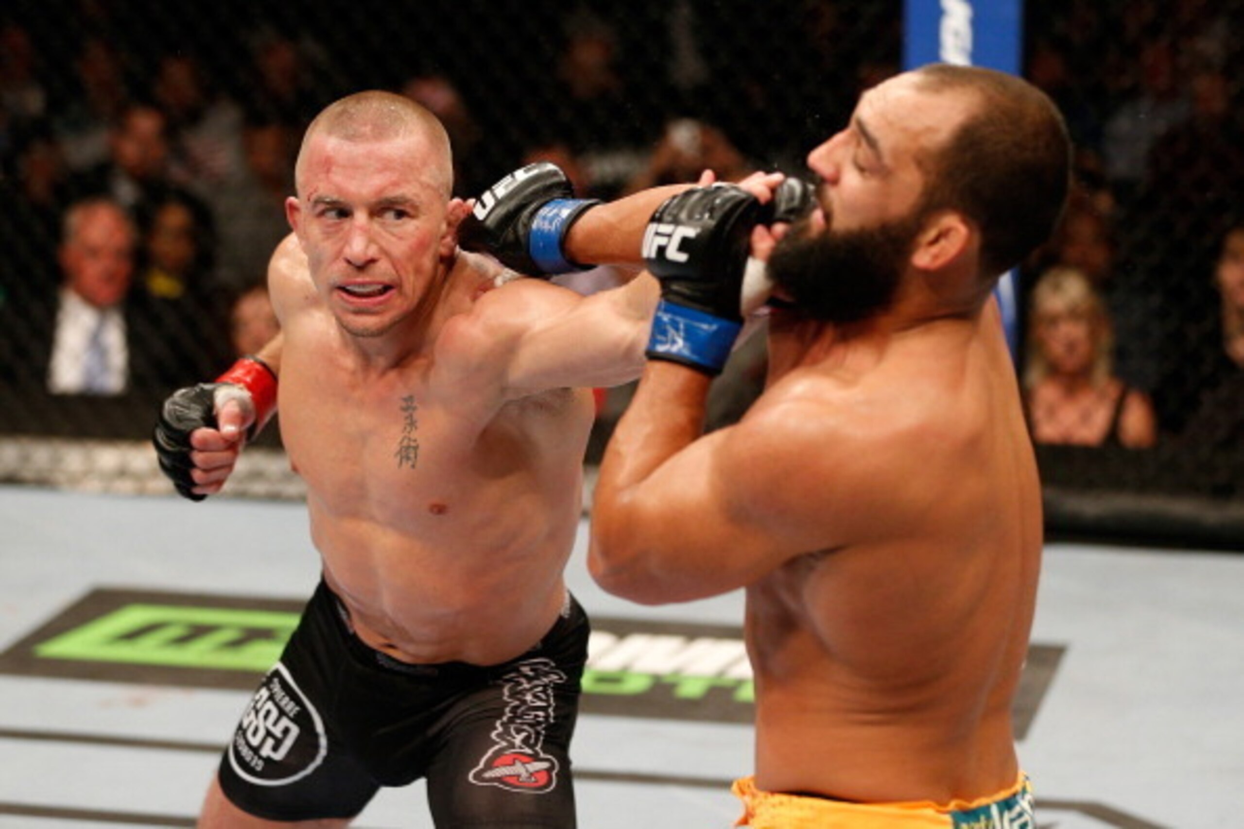 LAS VEGAS, NV - NOVEMBER 16:  (L-R) Georges St-Pierre punches Johny Hendricks in their UFC welterweight championship bout during the UFC 167 event inside the MGM Grand Garden Arena on November 16, 2013 in Las Vegas, Nevada. (Photo by Josh Hedges/Zuffa LLC