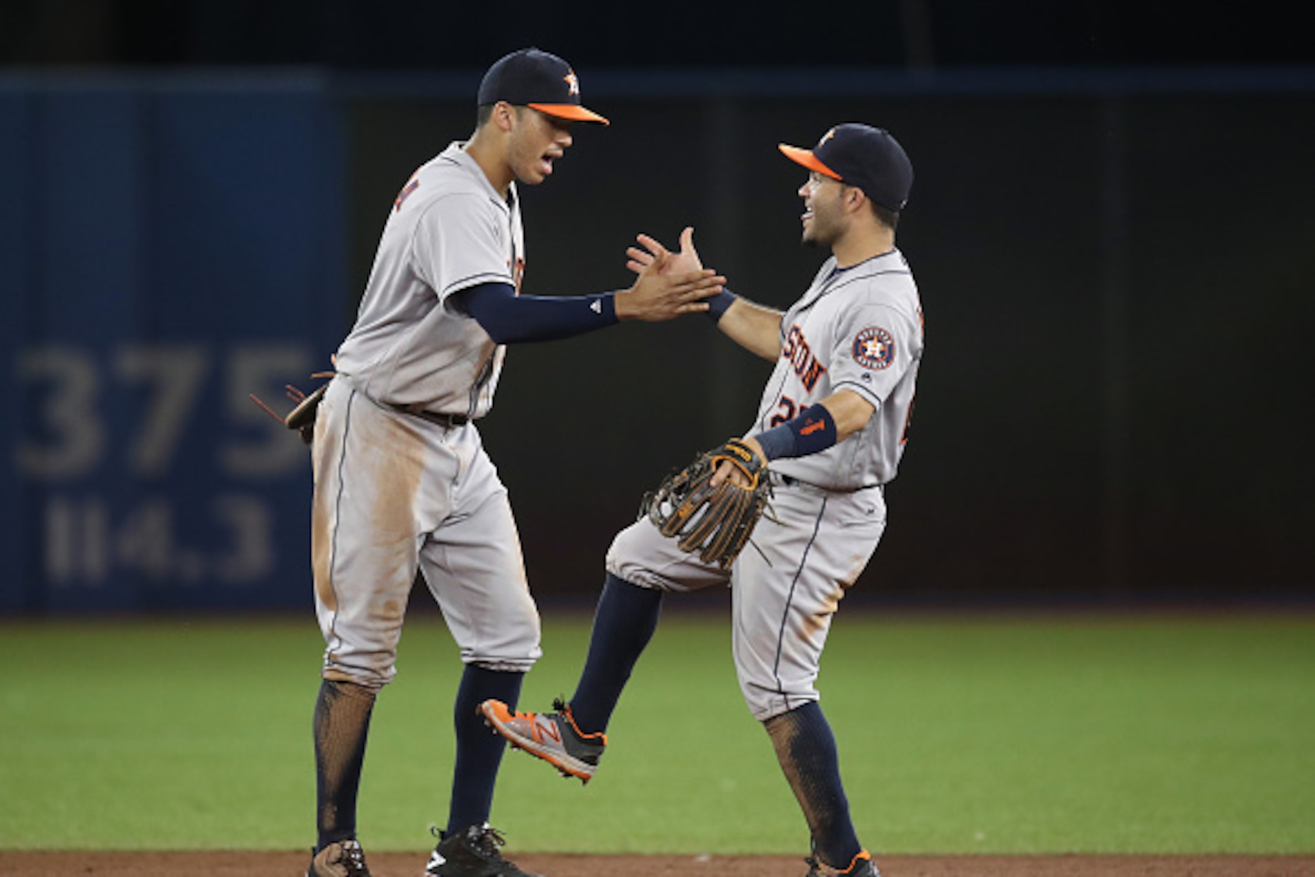 TORONTO, CANADA - AUGUST 12: Carlos Correa #1 of the Houston Astros celebrates their victory with Jose Altuve #27 during MLB game action against the Toronto Blue Jays on August 12, 2016 at Rogers Centre in Toronto, Ontario, Canada. (Photo by Tom Szczerbow