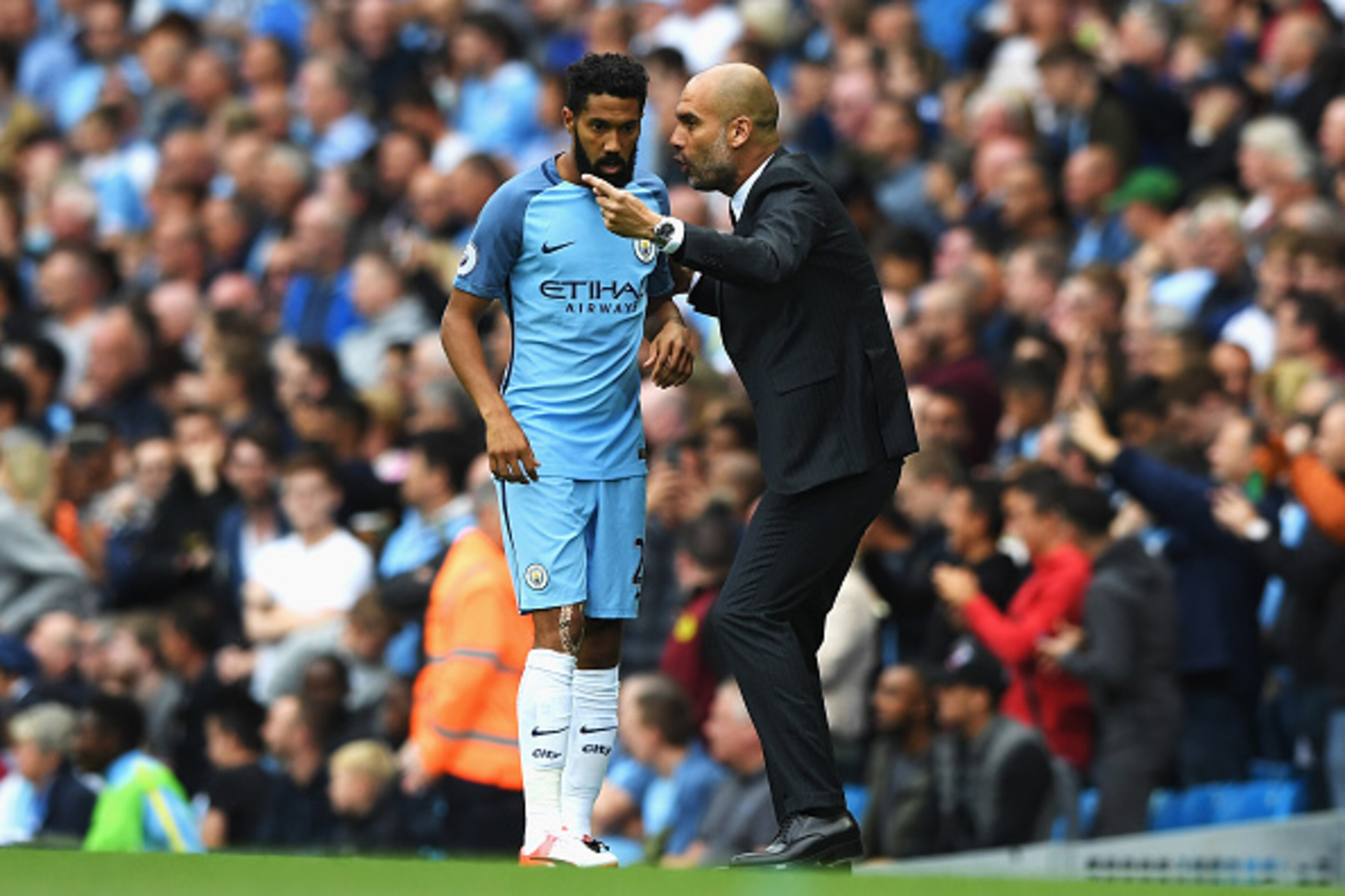 MANCHESTER, ENGLAND - AUGUST 13: Gael Clichy of Manchester City gets instructins from Josep Guardiola, Manager of Manchester City during the Premier League match between Manchester City and Sunderland at Etihad Stadium on August 13, 2016 in Manchester, En