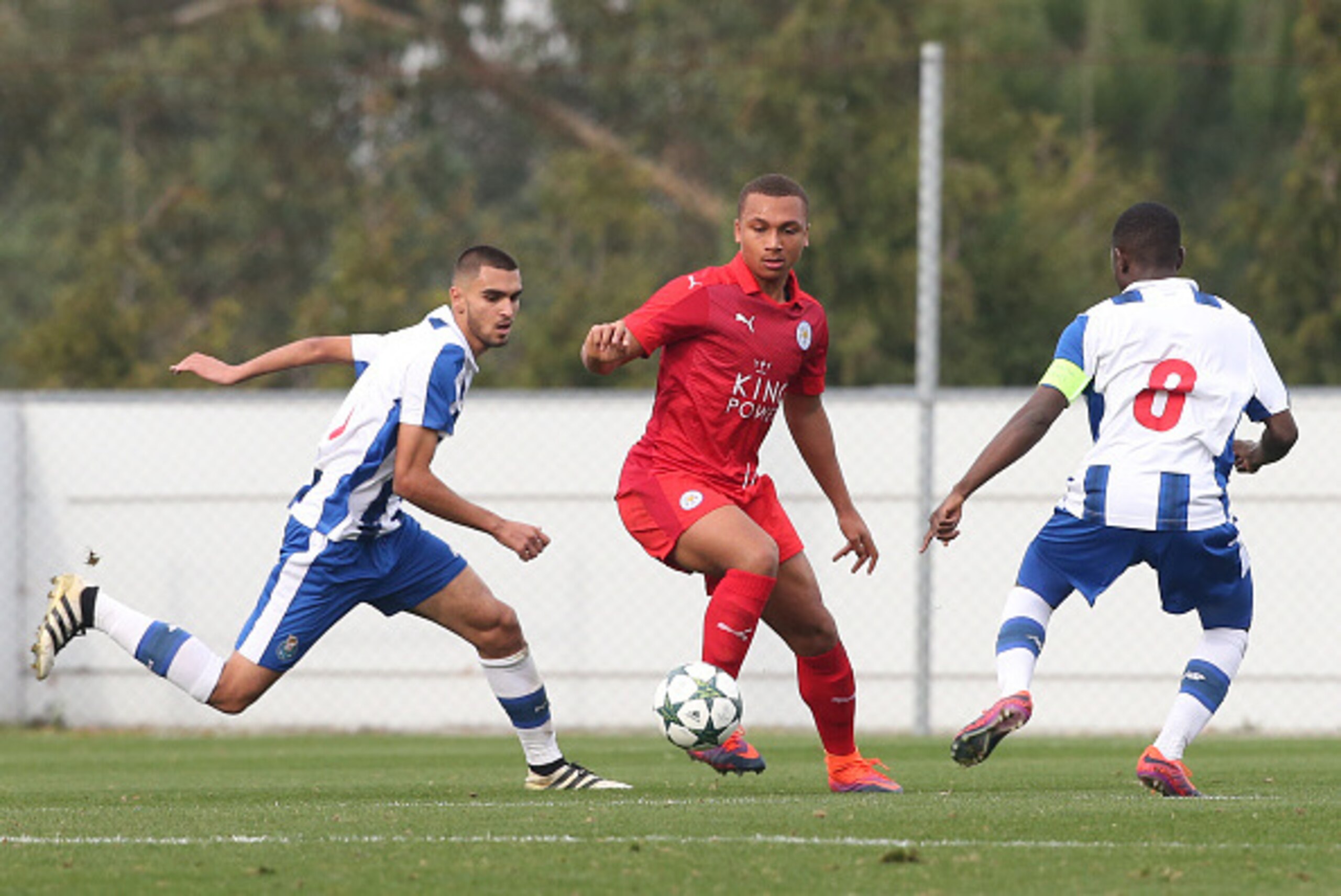OLIVAL, PORTUGAL - DECEMBER 7: Layton Ndukwu of Leicester City FC (C) with FC Porto's midfielder Rui Pires (L) and FC Porto's midfielder Moreto Cassama (R) in action during the UEFA Youth Champions League match between FC Porto and Leicester City FC at Ce