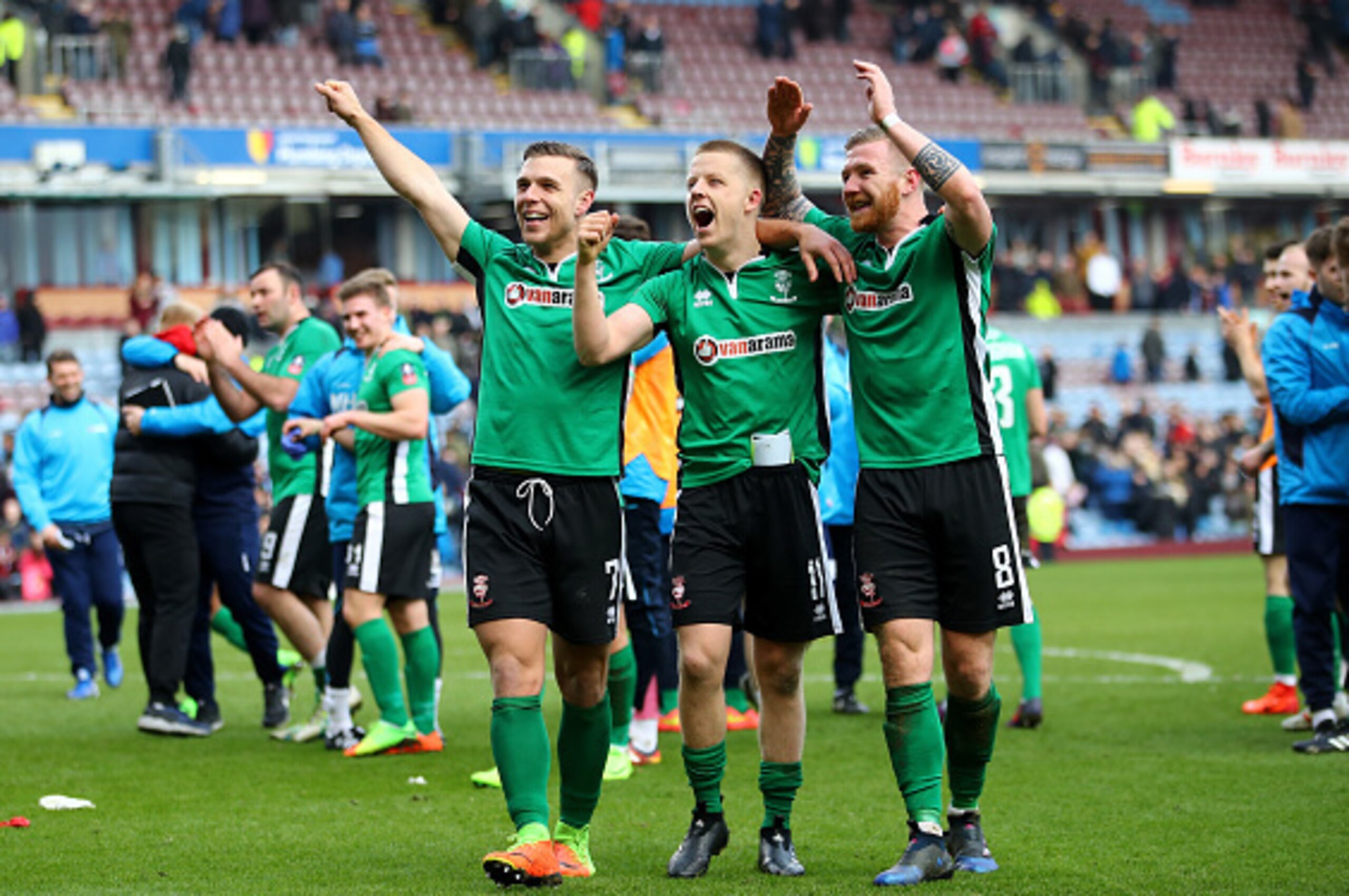 BURNLEY, ENGLAND - FEBRUARY 18:  Jack Muldoon of Lincoln City (L), Terry Hawkridge of Lincoln City (C) and Alan Power of Lincoln City (R) celebrate on the pitch after The Emirates FA Cup Fifth Round match between Burnley and Lincoln City at Turf Moor on F