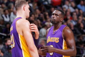 SACRAMENTO, CA - DECEMBER 12: Timofey Mozgov #20 and Luol Deng #9 of the Los Angeles Lakers talk during the game against the Sacramento Kings on December 12, 2016 at Golden 1 Center in Sacramento, California. NOTE TO USER: User expressly acknowledges and 