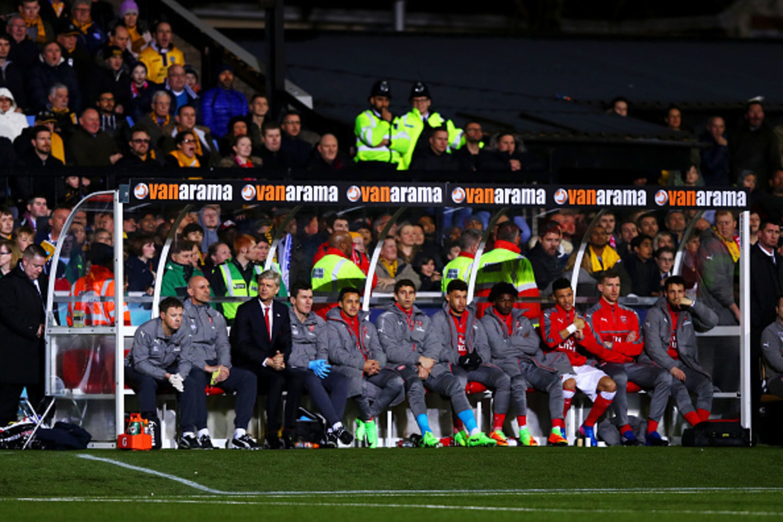 SUTTON, GREATER LONDON - FEBRUARY 20:  Arsene Wenger, manager of Arsenal sits on the bench with his coaching staff and substitutes before the Emirates FA Cup fifth round match between Sutton United and Arsenal on February 20, 2017 in Sutton, Greater Londo