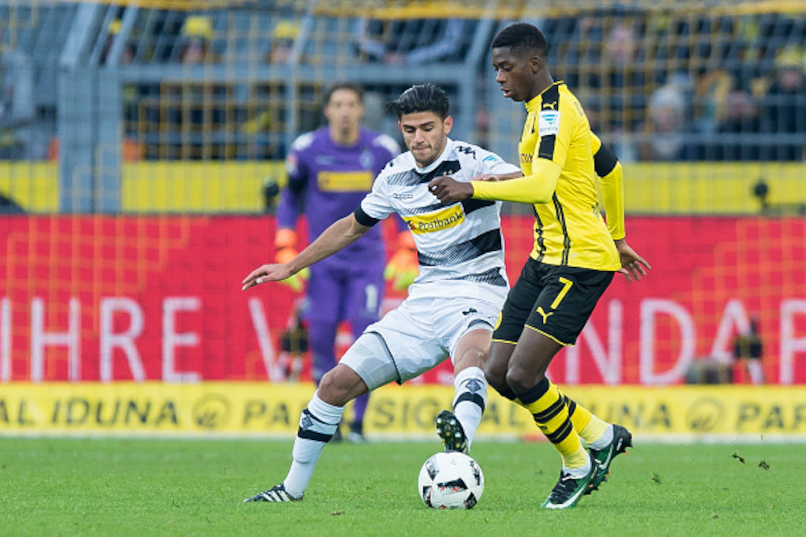 DORTMUND, GERMANY - DECEMBER 03: Mahmoud Dahoud of Moenchengladbach and Ousmane Dembele of Dortmund battle for the ball  during the Bundesliga match between Borussia Dortmund and Borussia Moenchengladbach at Signal Iduna Park on December 3, 2016 in Dortmu