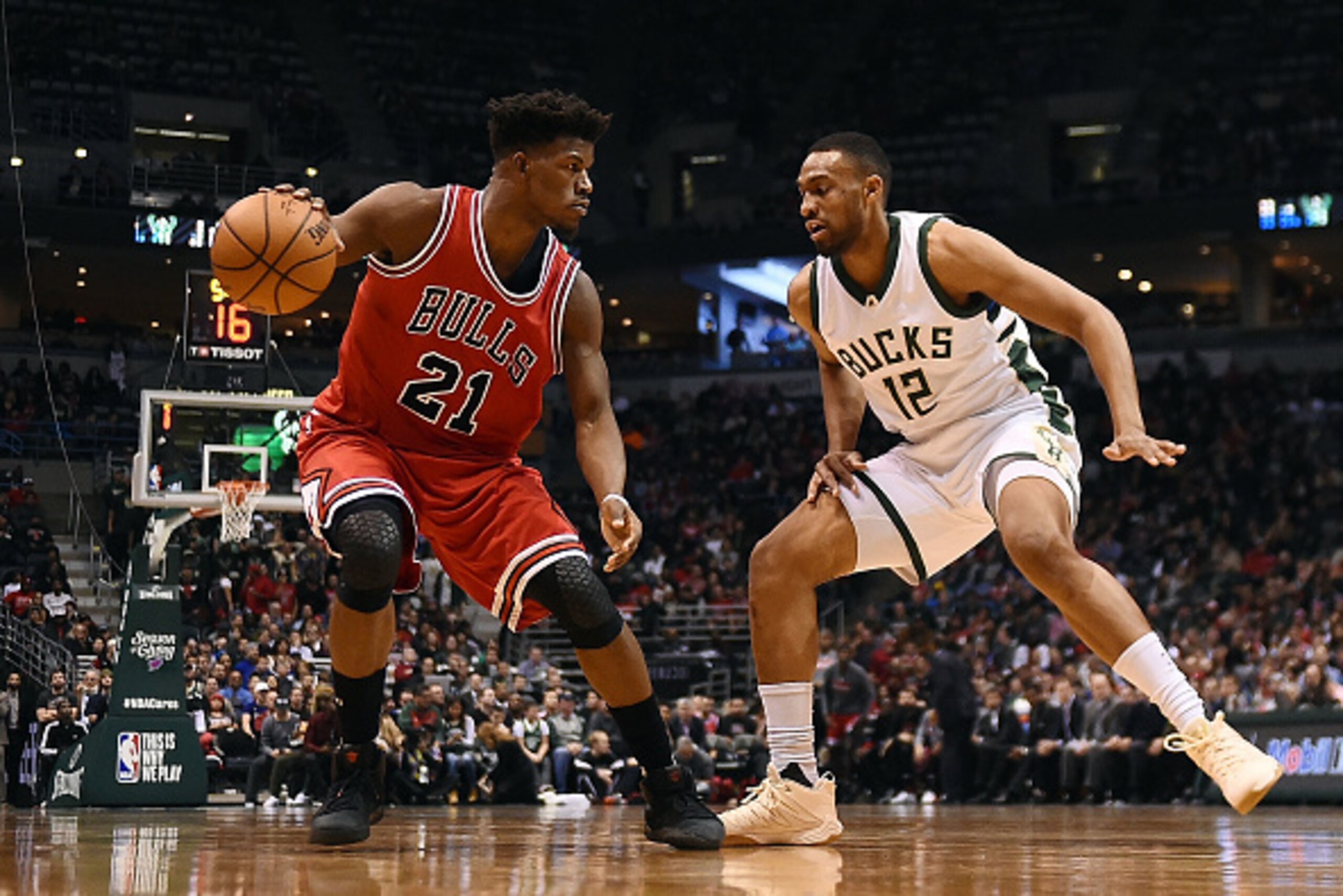 MILWAUKEE, WI - DECEMBER 15:  Jimmy Butler #21 of the Chicago Bulls is defended by Jabari Parker #12 of the Milwaukee Bucks during a game at the BMO Harris Bradley Center on December 15, 2016 in Milwaukee, Wisconsin.  The Bucks defeated the Bulls 108-97. 