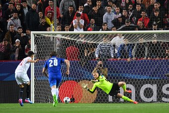 SEVILLE, SPAIN - FEBRUARY 22:  Kasper Schmeichel of Leicester City saves a penalty from Joaquin Correa of Sevilla during the UEFA Champions League Round of 16 first leg match between Sevilla FC and Leicester City at Estadio Ramon Sanchez Pizjuan on Februa