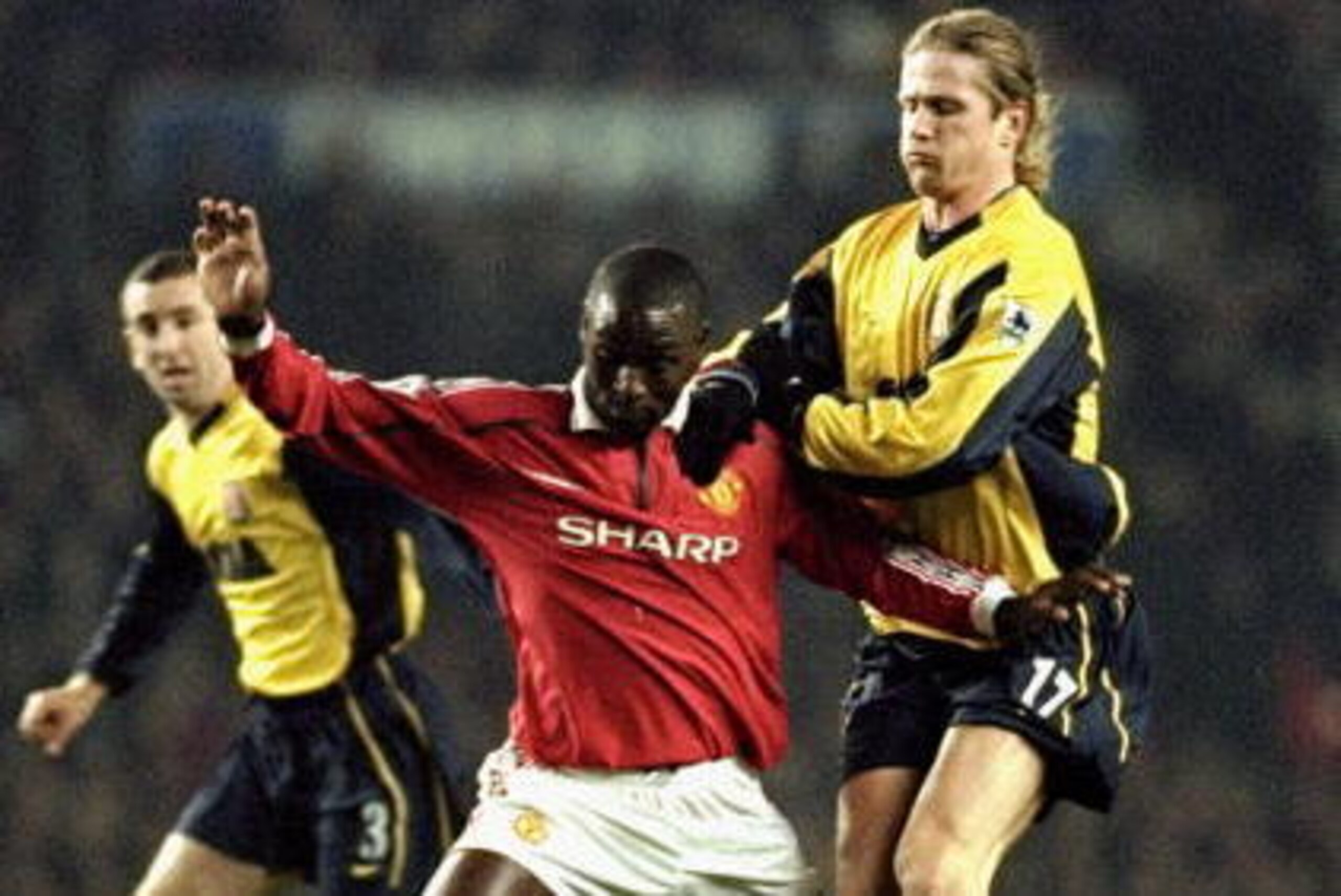 24 Jan 2000: Andy Cole of Manchester United shields the ball from Emmanuel Petit of Arsenal during the FA Carling Premier League match played at Old Trafford in Manchester, England. The game finished in a 1-1 draw. \ Mandatory Credit: Alex Livesey /Allsp 24 Jan 2000: Andy Cole of Manchester United shields the ball from Emmanuel Petit of Arsenal during the FA Carling Premier League match played at Old Trafford in Manchester, England. The game finished in a 1-1 draw. \ Mandatory Credit: Alex Livesey /Allsp