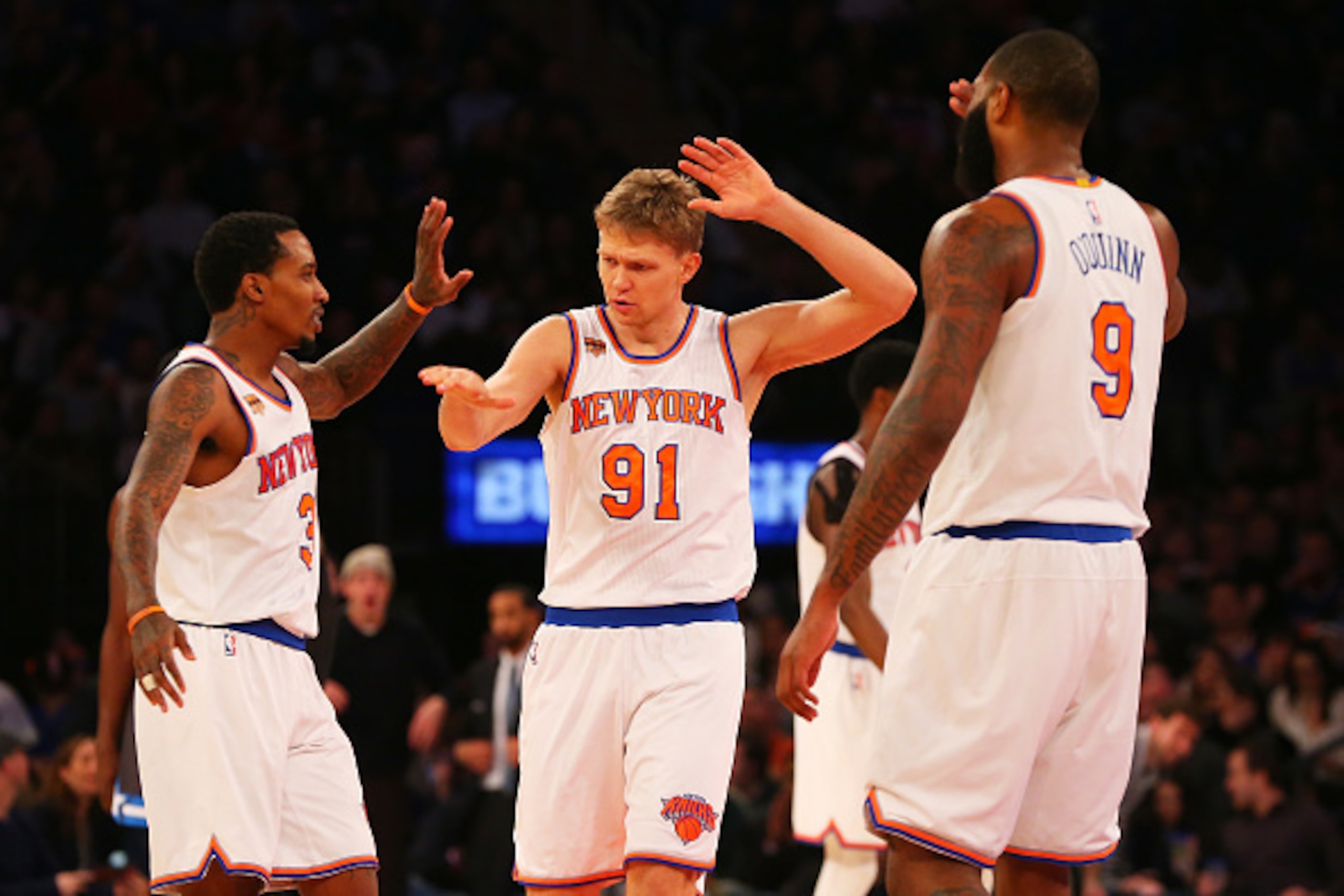 NEW YORK, NY - DECEMBER 22:  Brandon Jennings #3, Mindaugas Kuzminskas #91 and Kyle O'Quinn #9 of the New York Knicks celebrate a basket against the Orlando Magic at Madison Square Garden on December 22, 2016 in New York City.  (Photo by Mike Stobe/Getty 