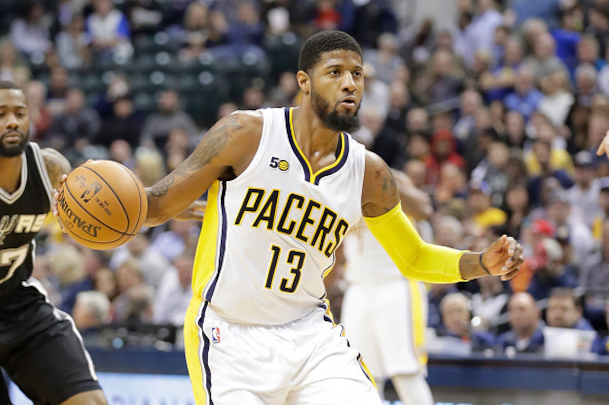 INDIANAPOLIS, IN - FEBRUARY 13: Paul George #13 of the Indiana Pacers dribbles the ball against the San Antonio Spurs at Bankers Life Fieldhouse on February 13, 2017 in Indianapolis, Indiana. NOTE TO USER: User expressly acknowledges and agrees that, INDIANAPOLIS, IN - FEBRUARY 13: Paul George #13 of the Indiana Pacers dribbles the ball against the San Antonio Spurs at Bankers Life Fieldhouse on February 13, 2017 in Indianapolis, Indiana. NOTE TO USER: User expressly acknowledges and agrees that,