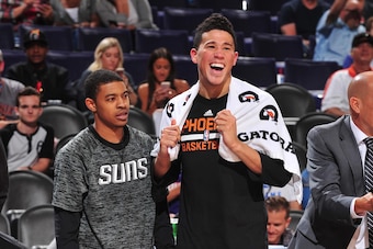 Tyler Ulis and Devin Booker of the Phoenix Suns stand together at a preseason game against the San Antonio Spurs on October 3, 2016 at Talking Stick Resort Arena in Phoenix, Arizona.