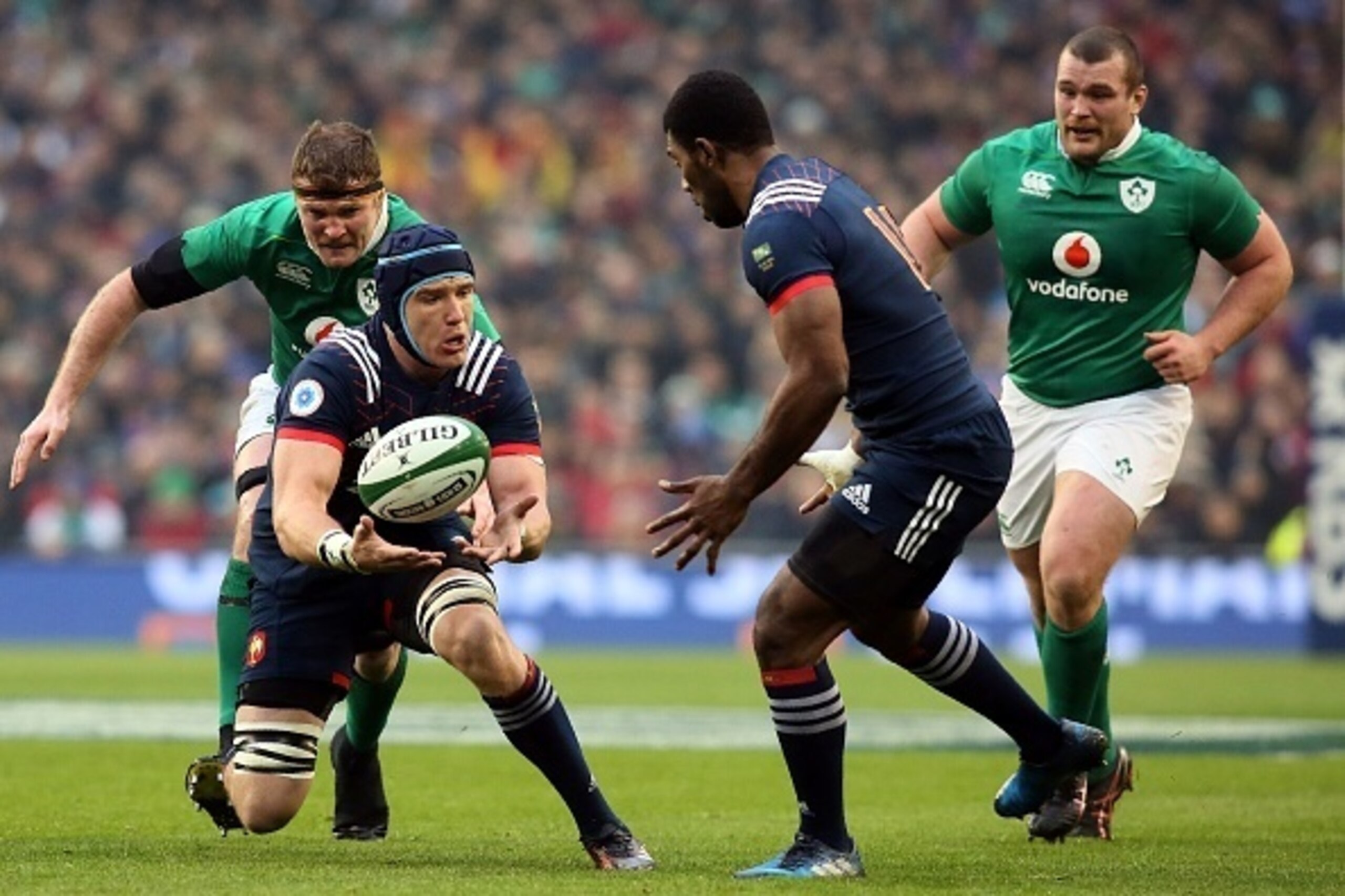 France's flanker Bernard Le Roux (2L) pases to France's wing Noa Seru Nakaitaci during the Six Nations international rugby union match between Ireland and France at the Aviva Stadium in Dublin on February 25, 2017.   / AFP / Paul FAITH        (Photo credi