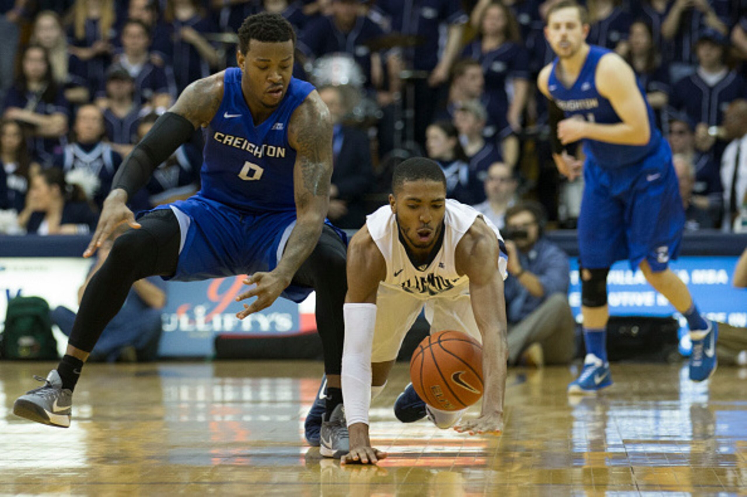 PHILADELPHIA, PA - FEBRUARY 25: Mikal Bridges #25 of the Villanova Wildcats dives for the ball against Marcus Foster #0 of the Creighton Bluejays in the second half at the Pavilion on February 25, 2017 in Villanova, Pennsylvania. The Wildcats defeated the