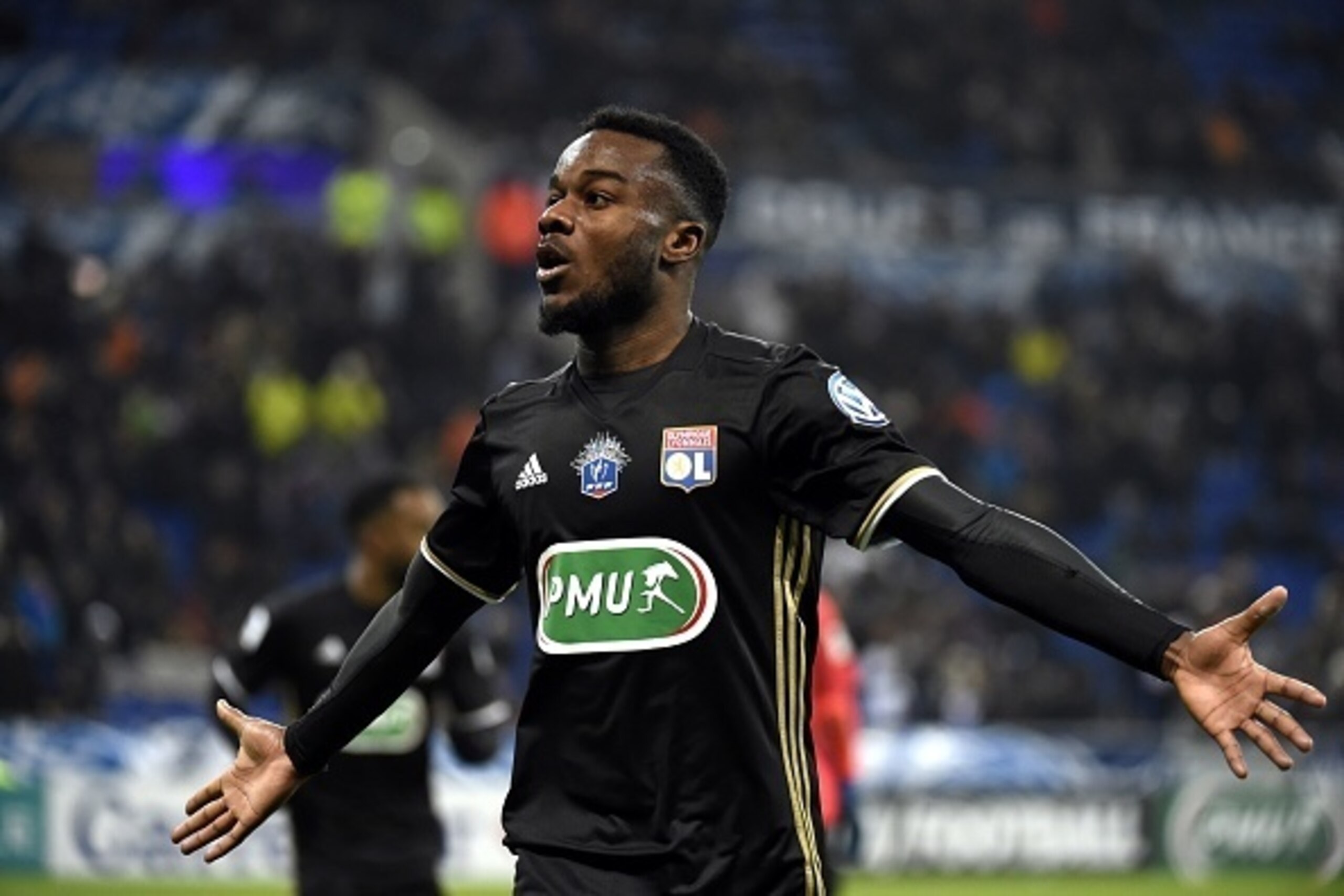 Lyon's French forward Maxwel Cornet celebrates after scoring during the French Cup football match between Olympique Lyonnais and Montpellier on January 8, 2017, at the Parc Olympique Lyonnais, nicknamed the Grand Stade in Lyon, eastern France. / AFP / PHI