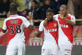 Monaco's French midfielder Thomas Lemar (C) celebrates with Monaco's French forward Kylian Mbappe (R) after scoring a goal during the French L1 football match Monaco (ASM) vs Bastia (SCB) on December 3, 2016 at the 'Louis II Stadium' in Monaco.   / AFP / 
