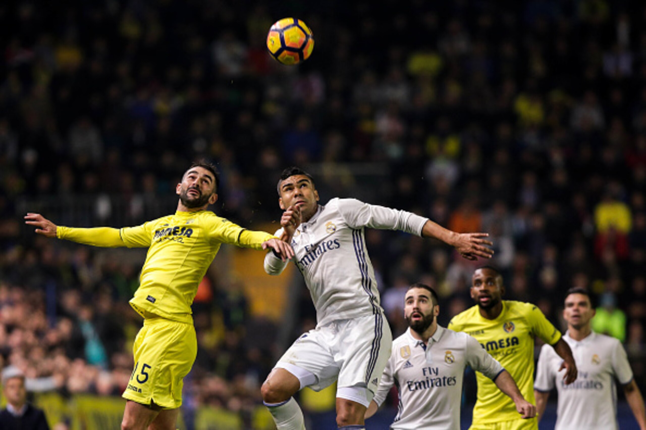 Villarreal's forward Adrian Lopez (L) vies with Real Madrid's Brazilian midfielder Casemiro during the Spanish League football match Villarreal CF vs Real Madrid at El Madrigal stadium in Vila-real on February 26, 2017. / AFP / BIEL ALINO (Photo c Villarreal's forward Adrian Lopez (L) vies with Real Madrid's Brazilian midfielder Casemiro during the Spanish League football match Villarreal CF vs Real Madrid at El Madrigal stadium in Vila-real on February 26, 2017. / AFP / BIEL ALINO (Photo c