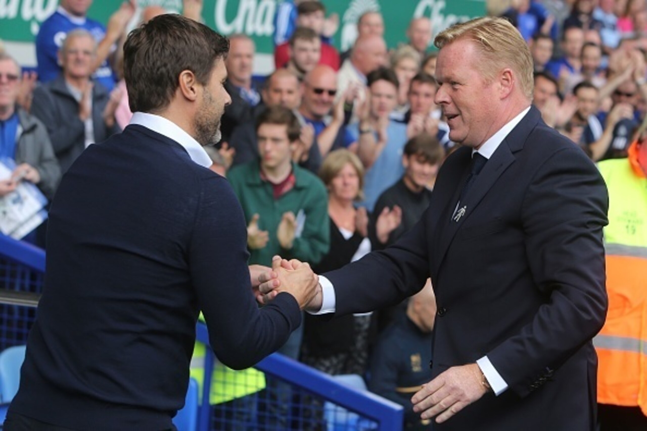 Everton's Dutch manager Ronald Koeman (R) is greeted by Tottenham Hotspur's Argentinian head coach Mauricio Pochettino (L) as they arrive for the English Premier League football match between Everton and Tottenham Hotspur at Goodison Park in Liverpool, no
