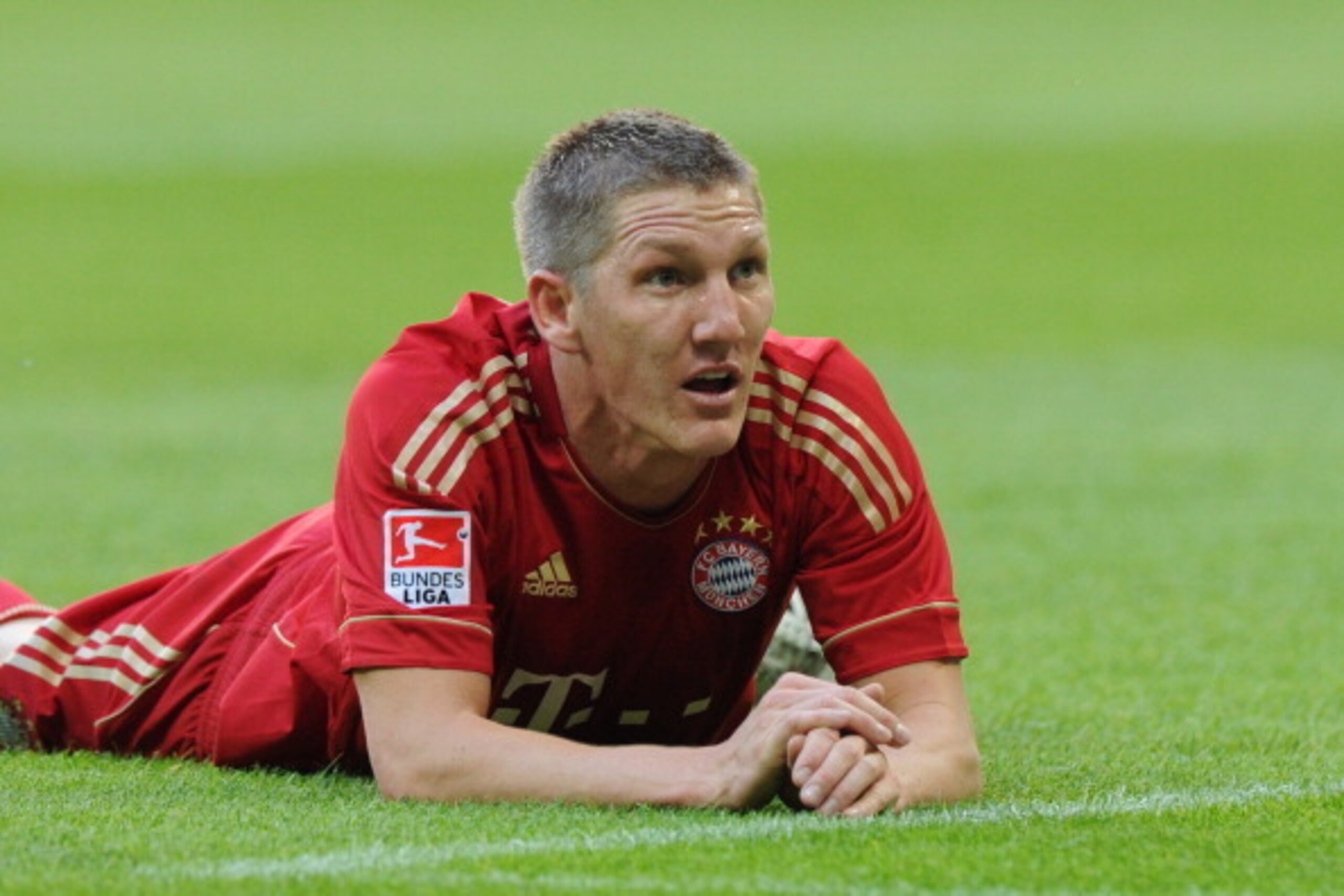 Bayern Munich's midfielder Bastian Schweinsteiger lays on the field during the German first division Bundesliga football match FC Bayern Munich vs Hertha BSC Berlin in the southern German city of Munich on October 15, 2011. Bayern Munich won the match 4-0