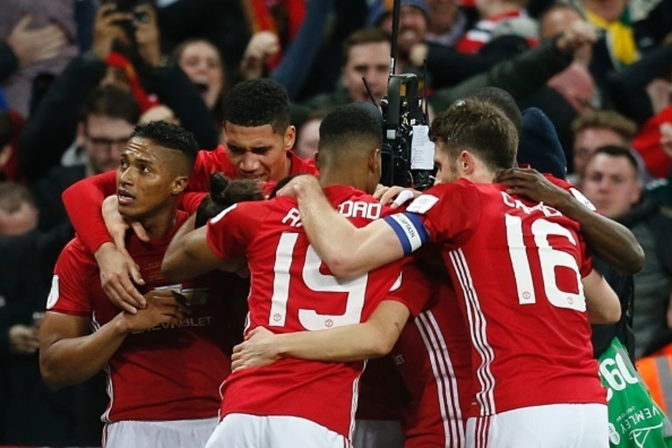Manchester United's Swedish striker Zlatan Ibrahimovic (C) celebrates with teammates after scoring their third goal during the English League Cup final football match between Manchester United and Southampton at Wembley stadium in north London on February