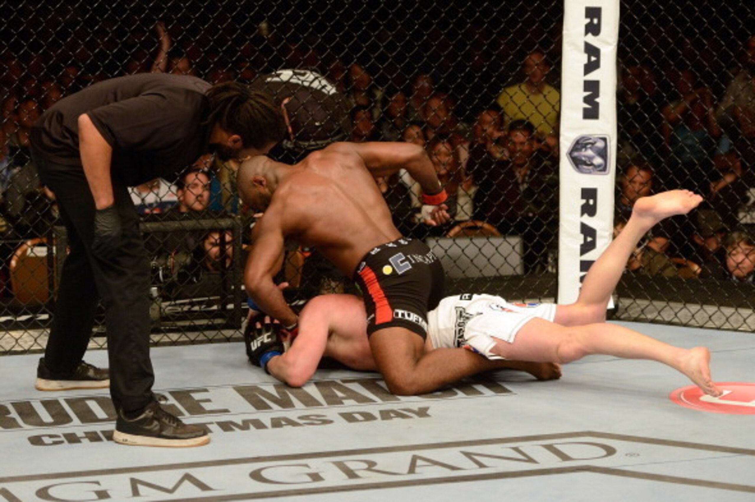 LAS VEGAS, NV - NOVEMBER 16:  Rashad Evans (top) punches Chael Sonnen as referee Herb Dean looks on in their light heavyweight bout during the UFC 167 event inside the MGM Grand Garden Arena on November 16, 2013 in Las Vegas, Nevada. (Photo by Donald Mira