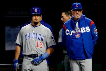 CLEVELAND, OH - OCTOBER 25:  Kyle Schwarber #12 and Joe Maddon #70 of the Chicago Cubs look on from the dugout prior to Game One of the 2016 World Series against the Cleveland Indians at Progressive Field on October 25, 2016 in Cleveland, Ohio.  (Photo by
