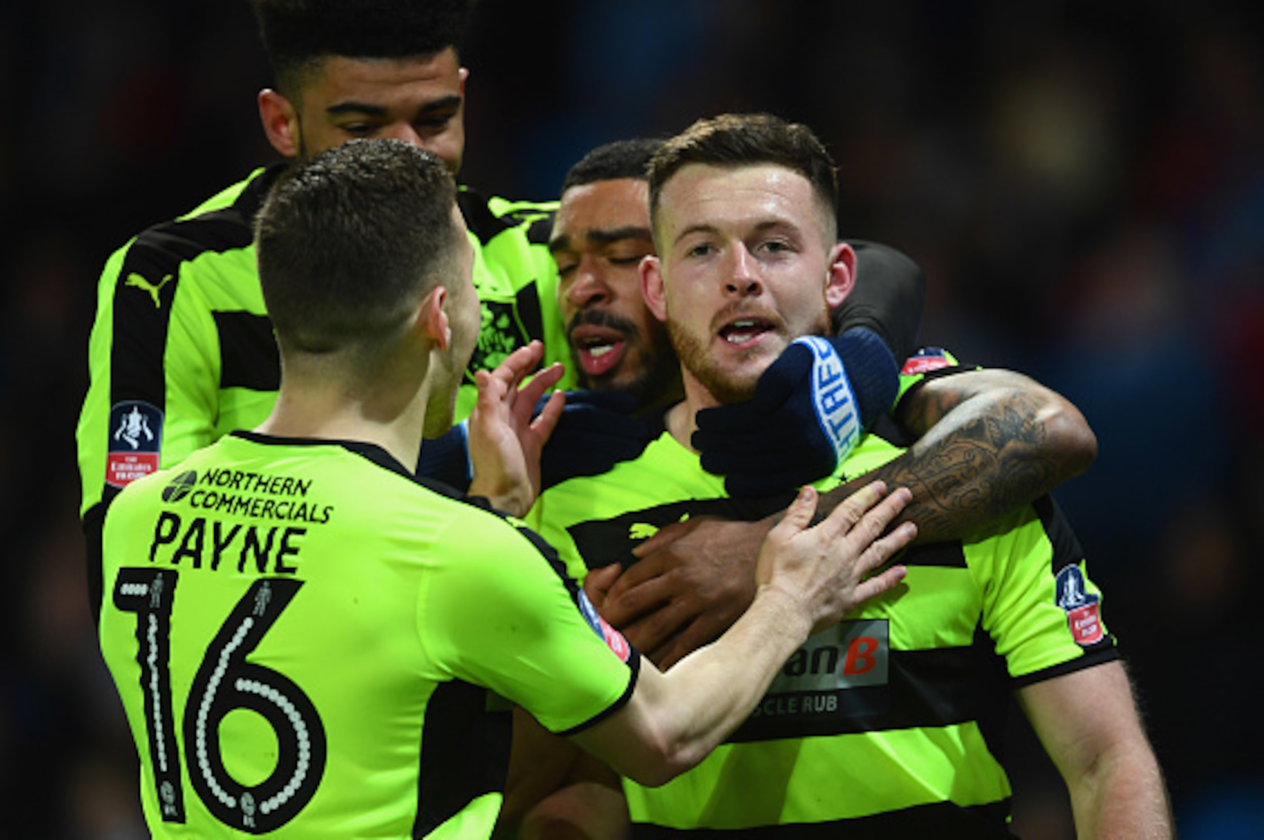 MANCHESTER, ENGLAND - MARCH 01:  Harry Bunn of Huddersfield Town (R) celebrates with team mates as he scores their first goal during The Emirates FA Cup Fifth Round Replay match between Manchester City and Huddersfield Town at Etihad Stadium on March 1, 2