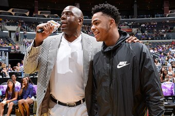 LOS ANGELES, CA - AUGUST 30: Los Angeles Sparks Owner Magic Johnson interviews D'Angelo Russell #1 of the Los Angeles Lakers during a game between the Los Angeles Sparks and the San Antonio Stars at STAPLES Center on August 30, 2015 in Los Angeles, Califo