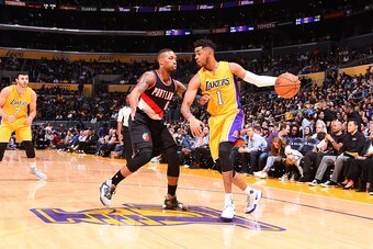 LOS ANGELES, CA - OCTOBER 11:  D'Angelo Russell #1 of the Los Angeles Lakers handles the ball against Damian Lillard #0 of the Portland Trail Blazers during a preseason game on October 11, 2016 at STAPLES Center in Los Angeles, California. NOTE TO USER: U