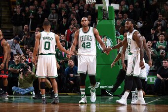 BOSTON, MA - DECEMBER 9: Al Horford #42 of the Boston Celtics high fives his teammates Avery Bradley #0 and Jae Crowder #99 of the Boston Celtics during the game against the Toronto Raptors on December 9, 2016 at TD Garden in Boston, Massachusetts. NOTE T